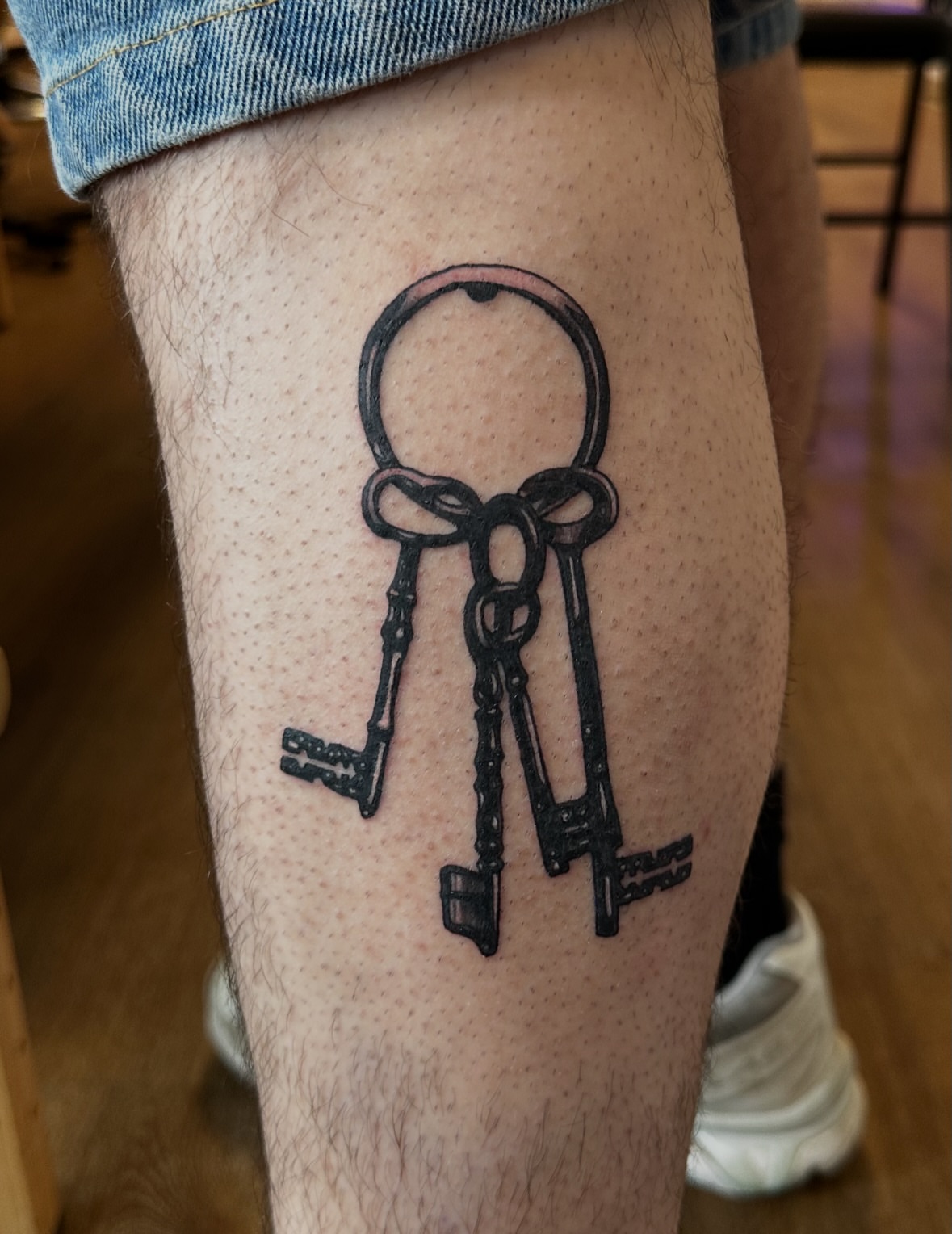 Keys black and grey tattoo on the forearm by Drew’s Tattoos (NH)