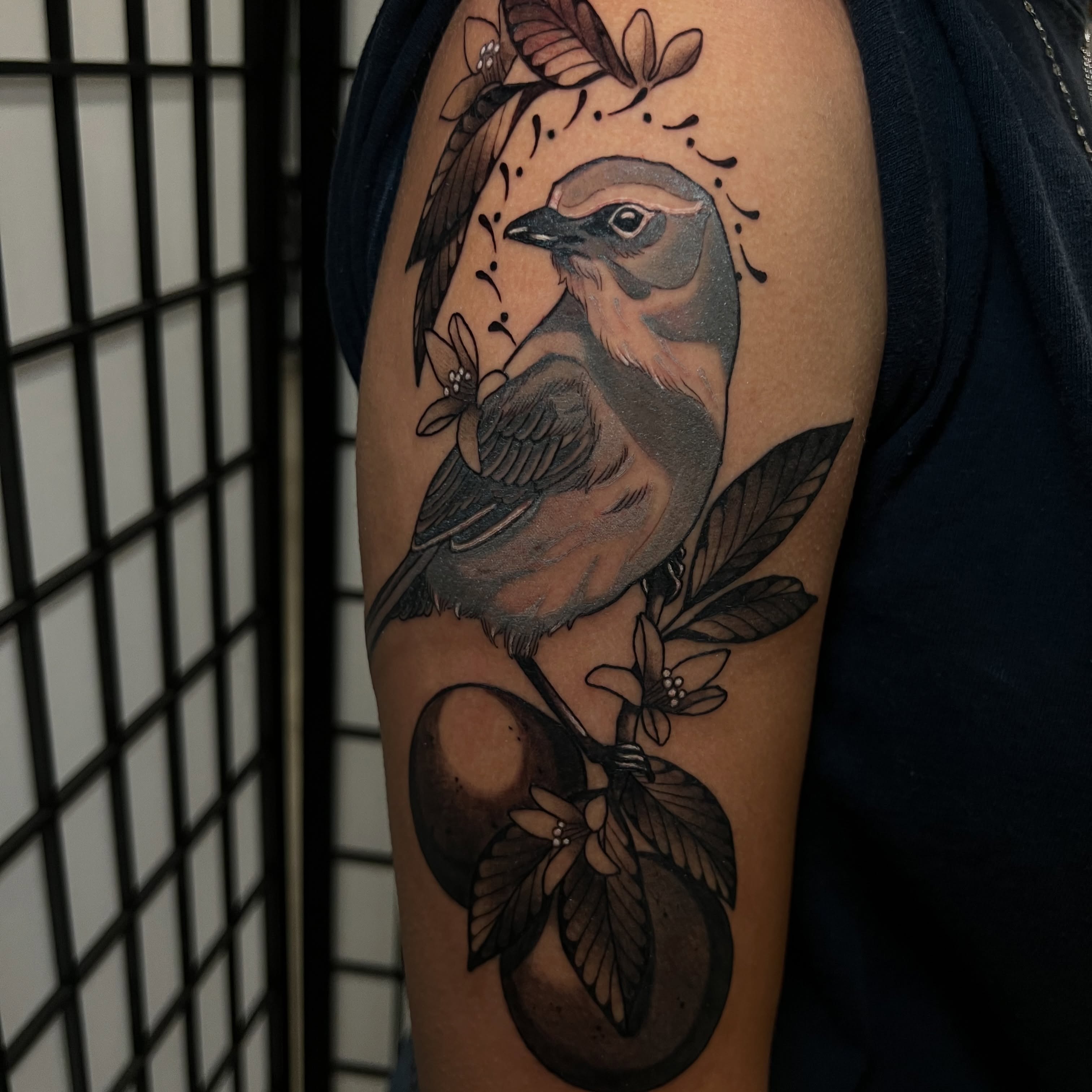 Bird and flowers realism tattoo on the forearm by Rennie Tattoo