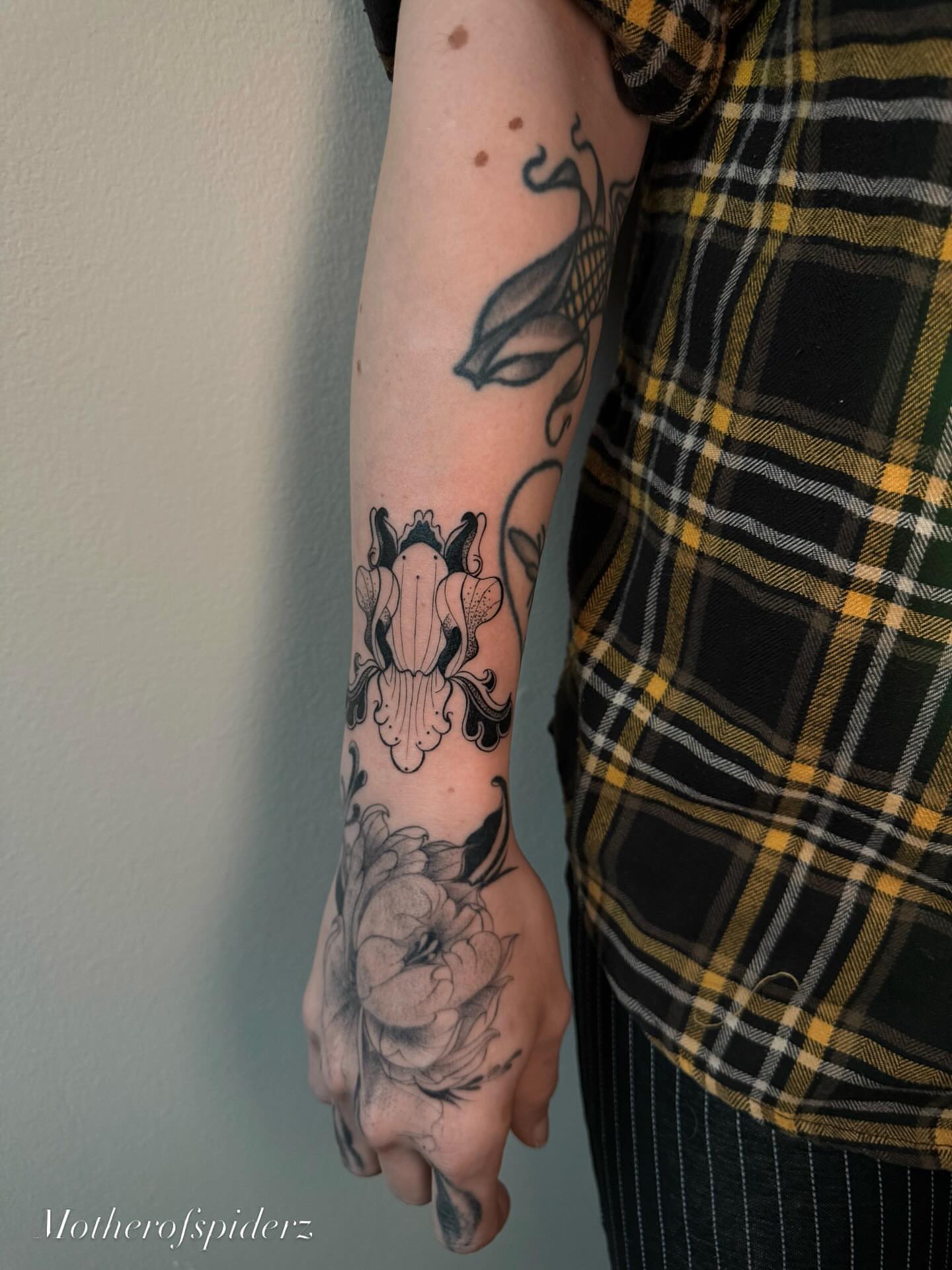 Peony and floral black and grey tattoo on the forearm by Alyssa Garza