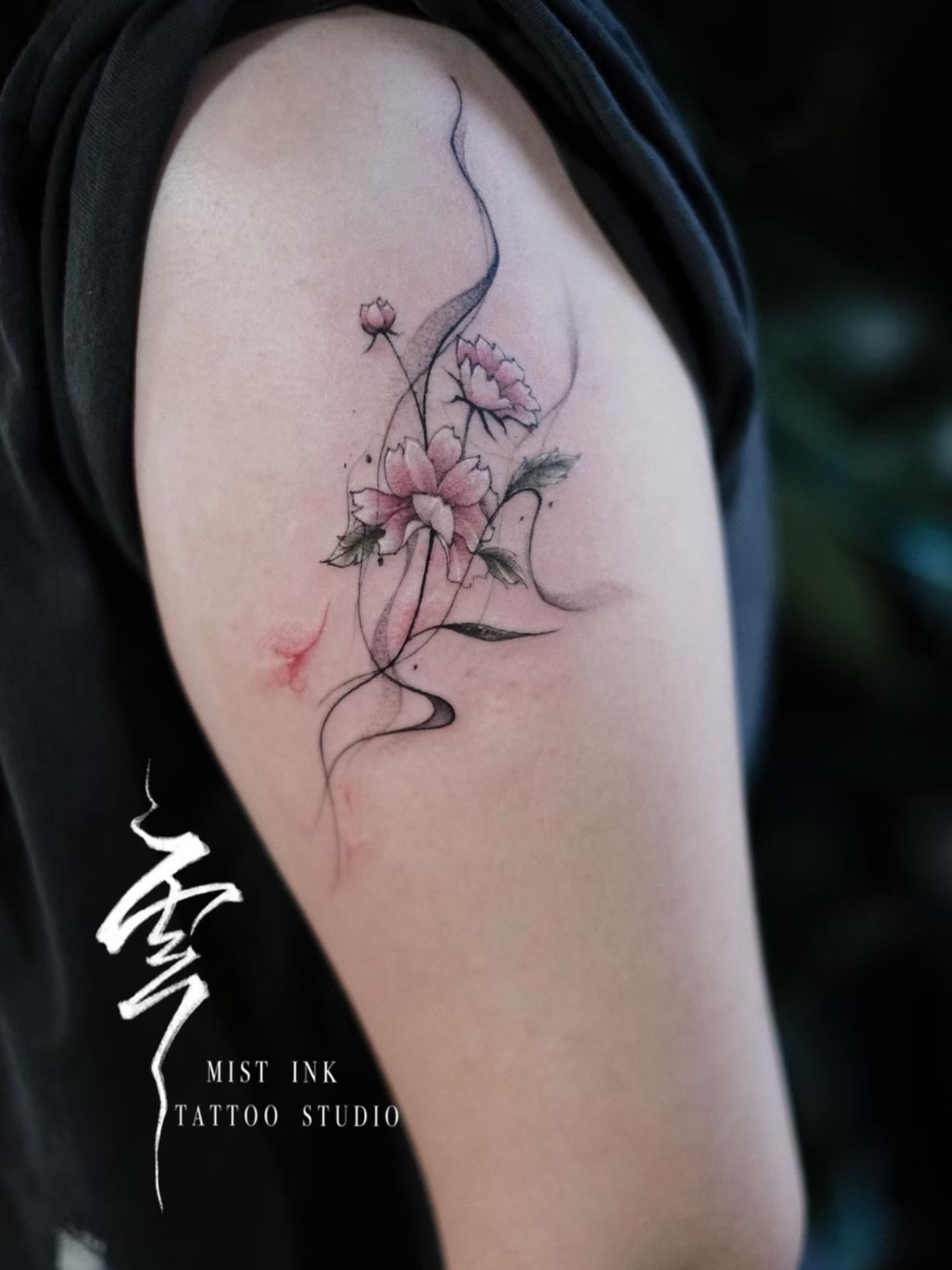 Floral arrangement watercolor tattoo on the upper arm by Ink _daisy_