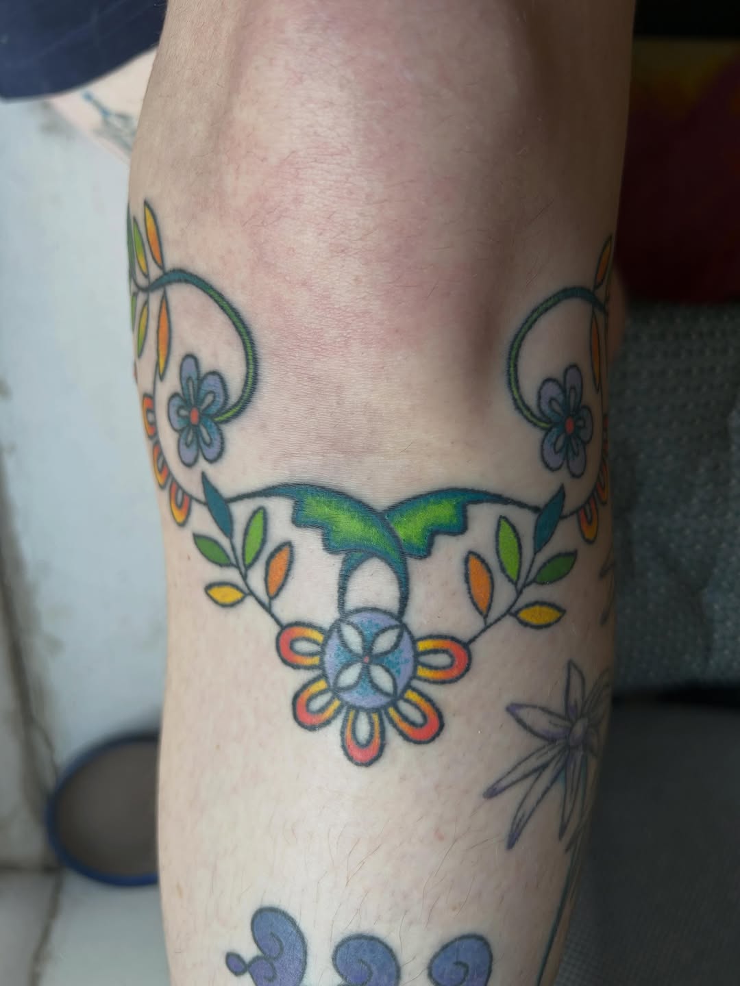Floral vine with hummingbird American traditional tattoo on the forearm by Emma D