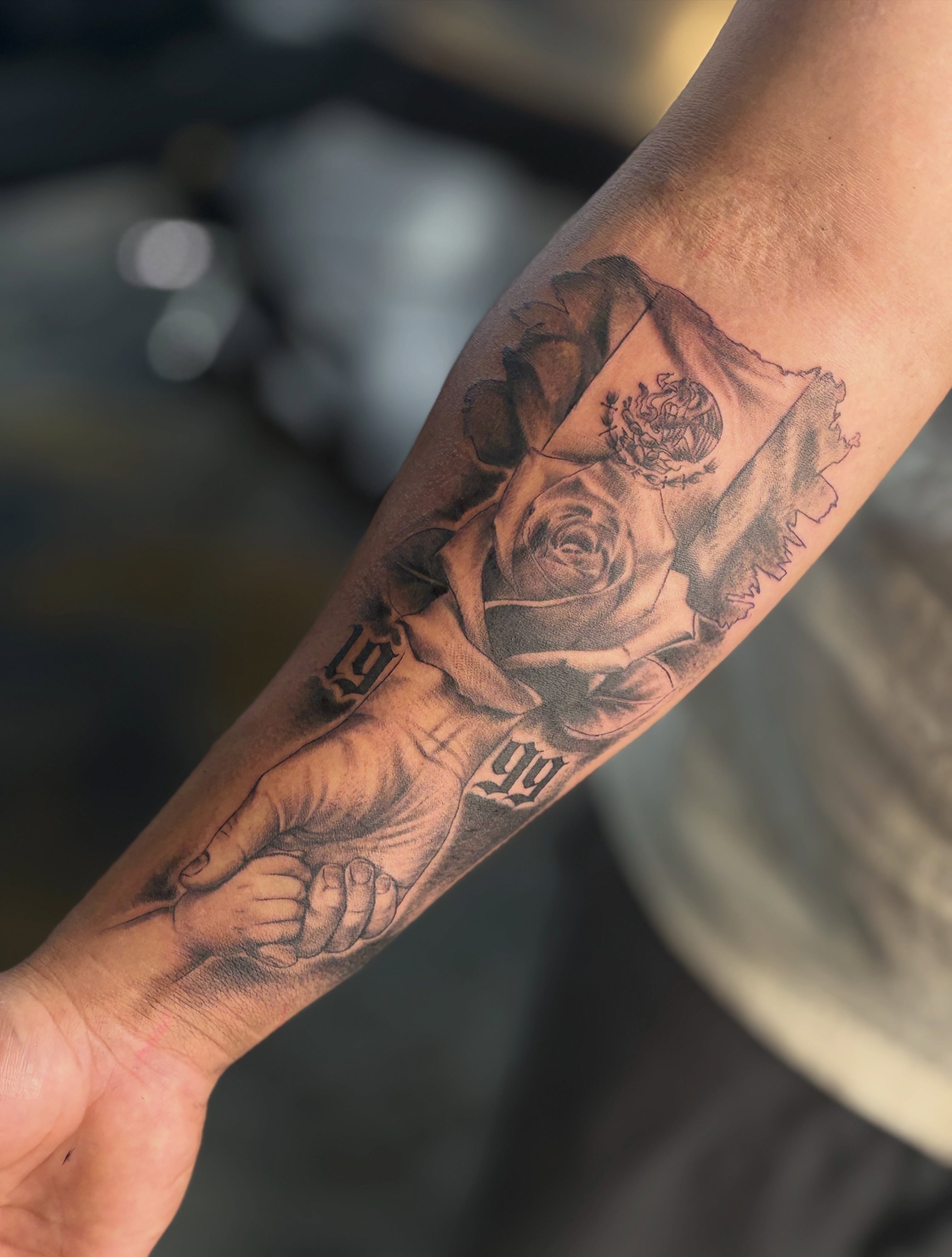 Rose and hand realism tattoo on the forearm by Kevin
