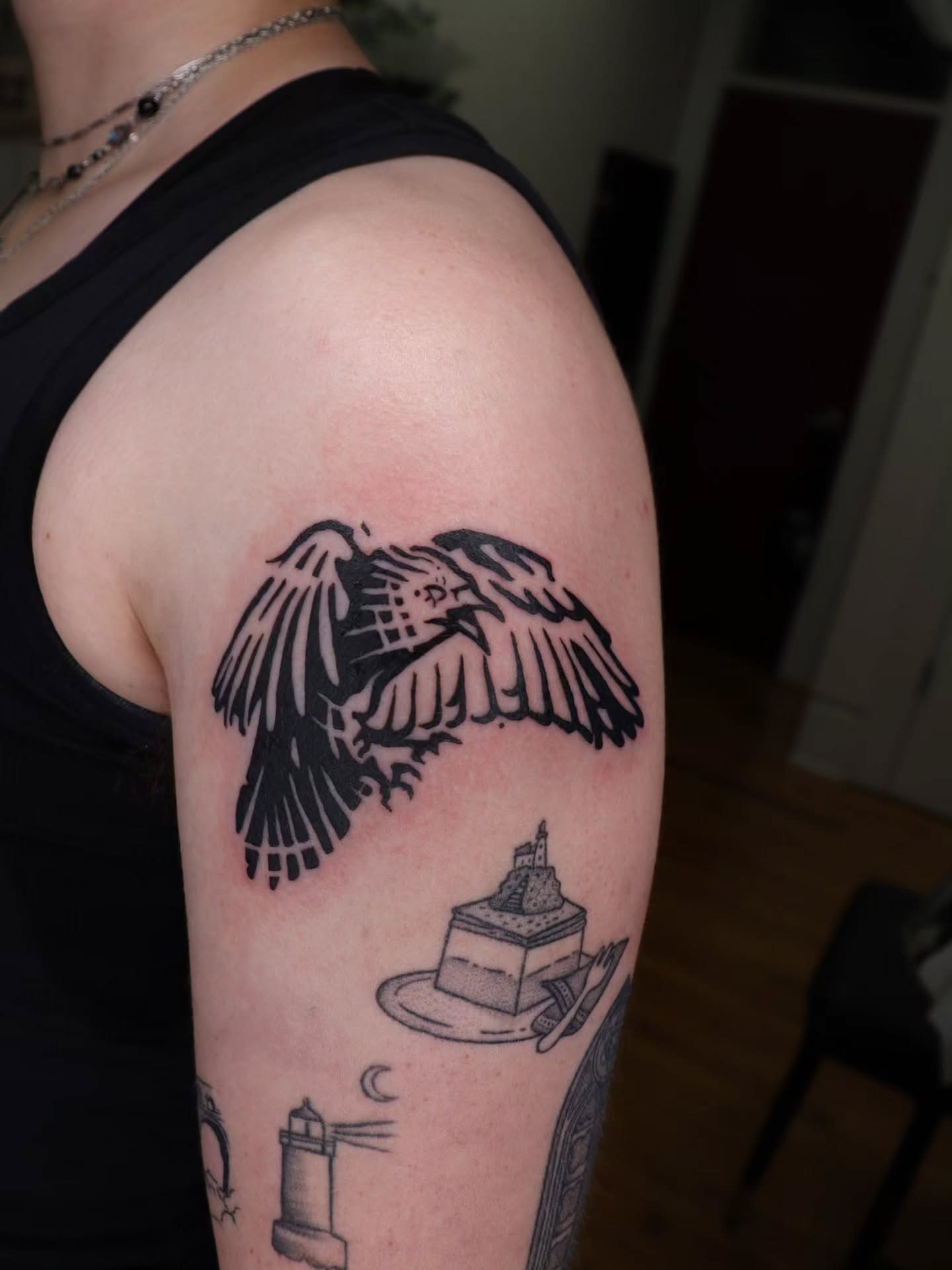 Eagle black and grey tattoo on the upper arm by Veronika Lipchak