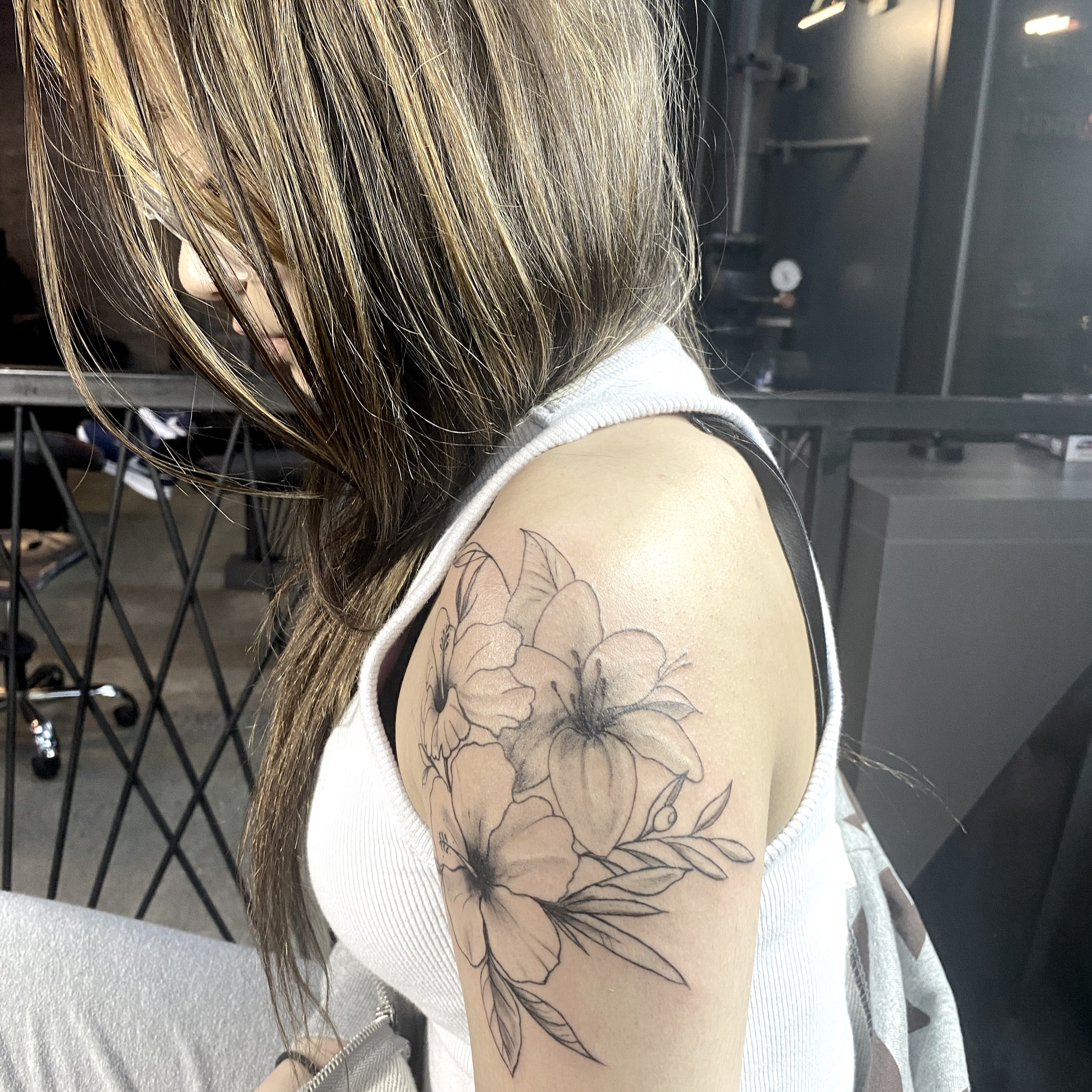 Floral arrangement black and grey tattoo on the shoulder by R o s e