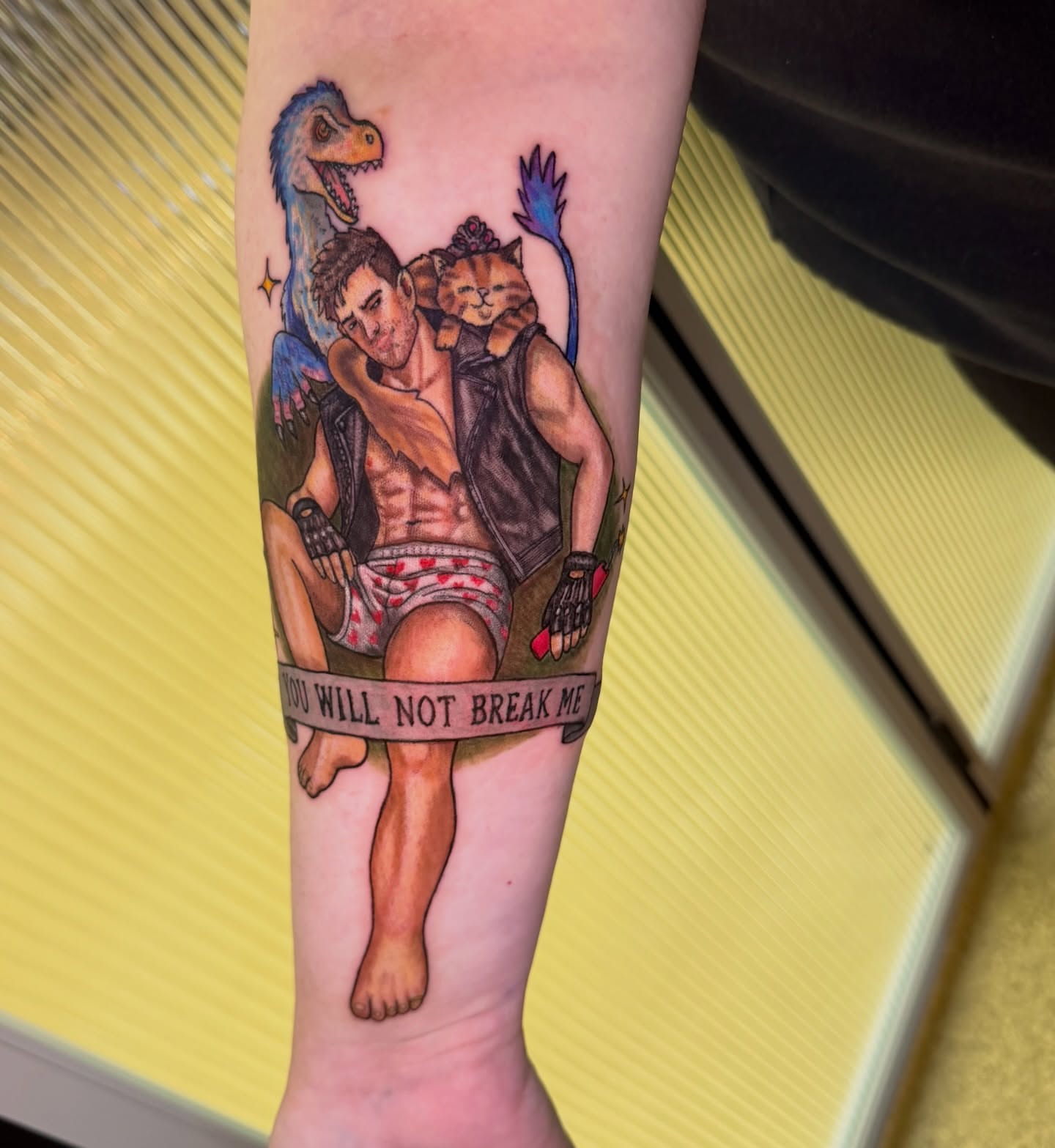 Man with cat and dinosaur realism tattoo on the forearm by Abbie Kaitlynn Taylor, Dayton, Ohio