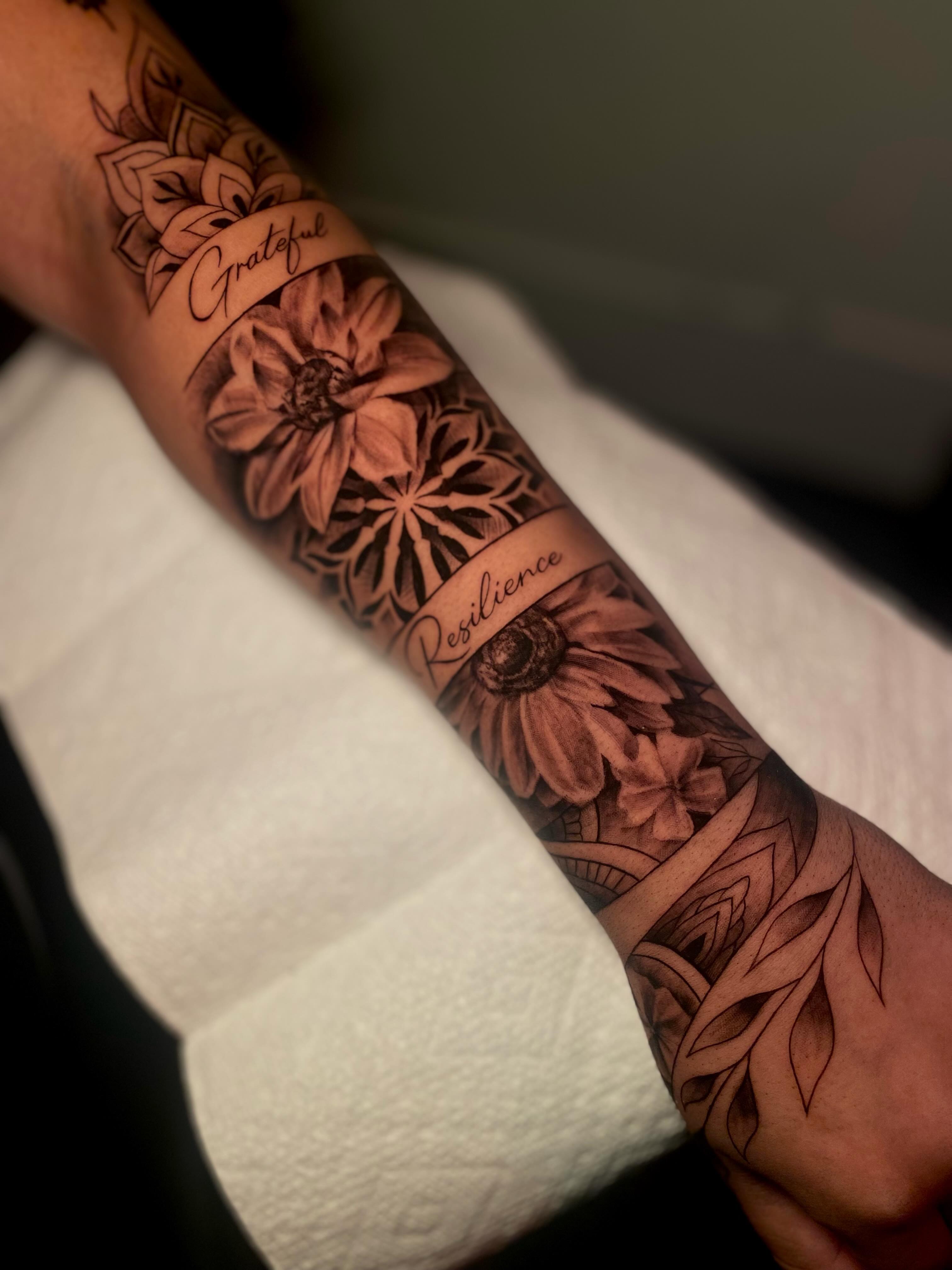 Sunflowers and mandalas realism tattoo on the forearm by Tattoo Artist