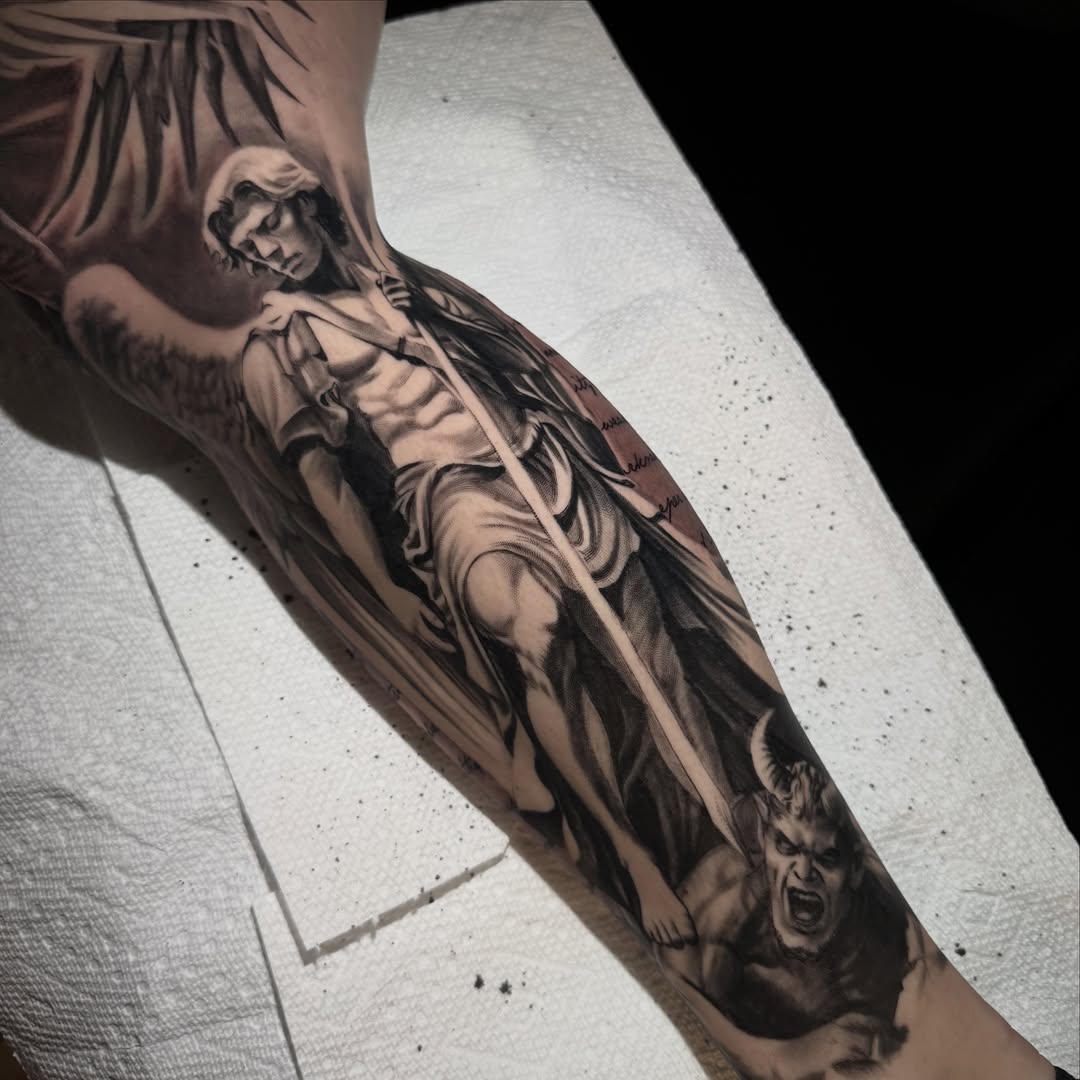 Angel and demon realism tattoo on the forearm by Jake Fujimura
