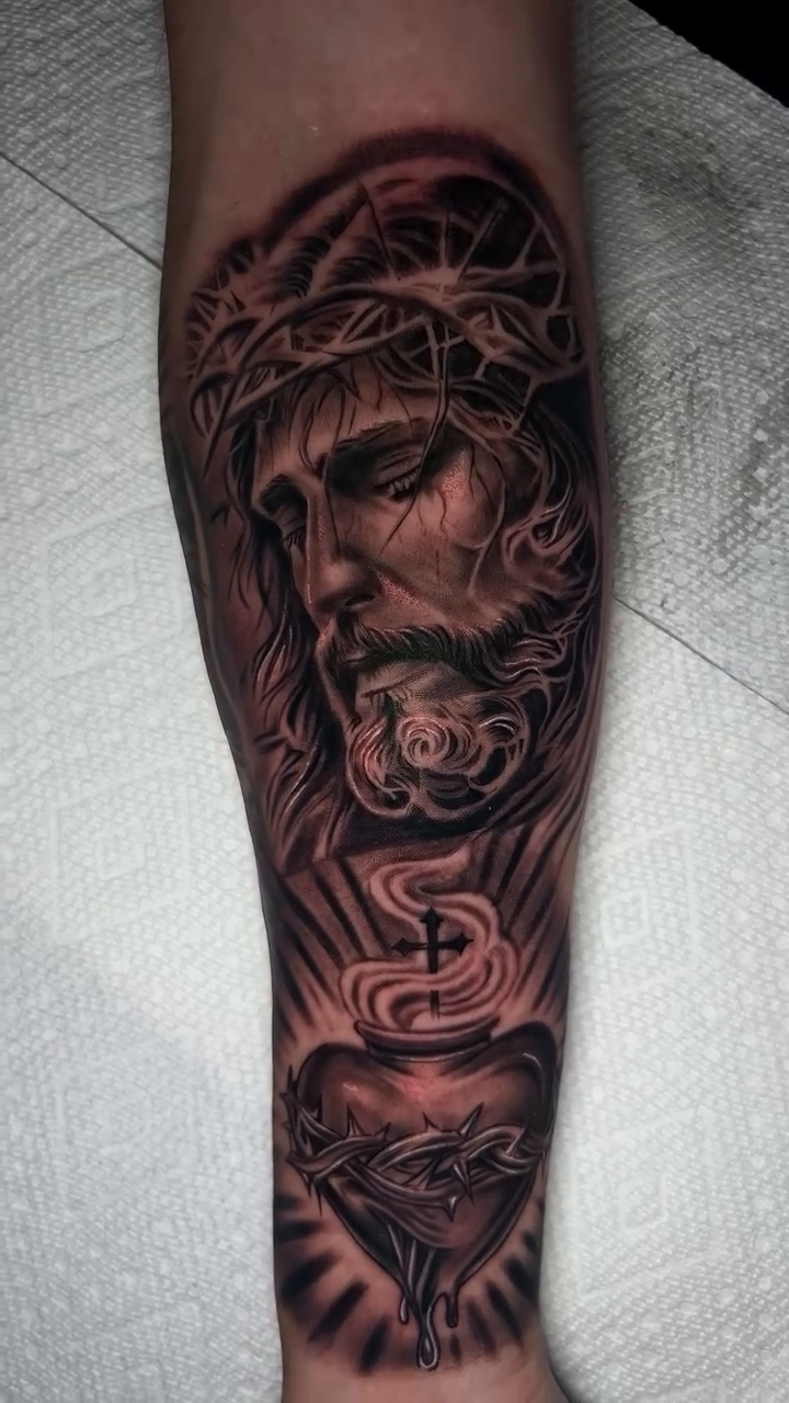 Jesus Christ and Sacred Heart tattoo Chicano tattoo on the upper arm by Kevyn Vidal
