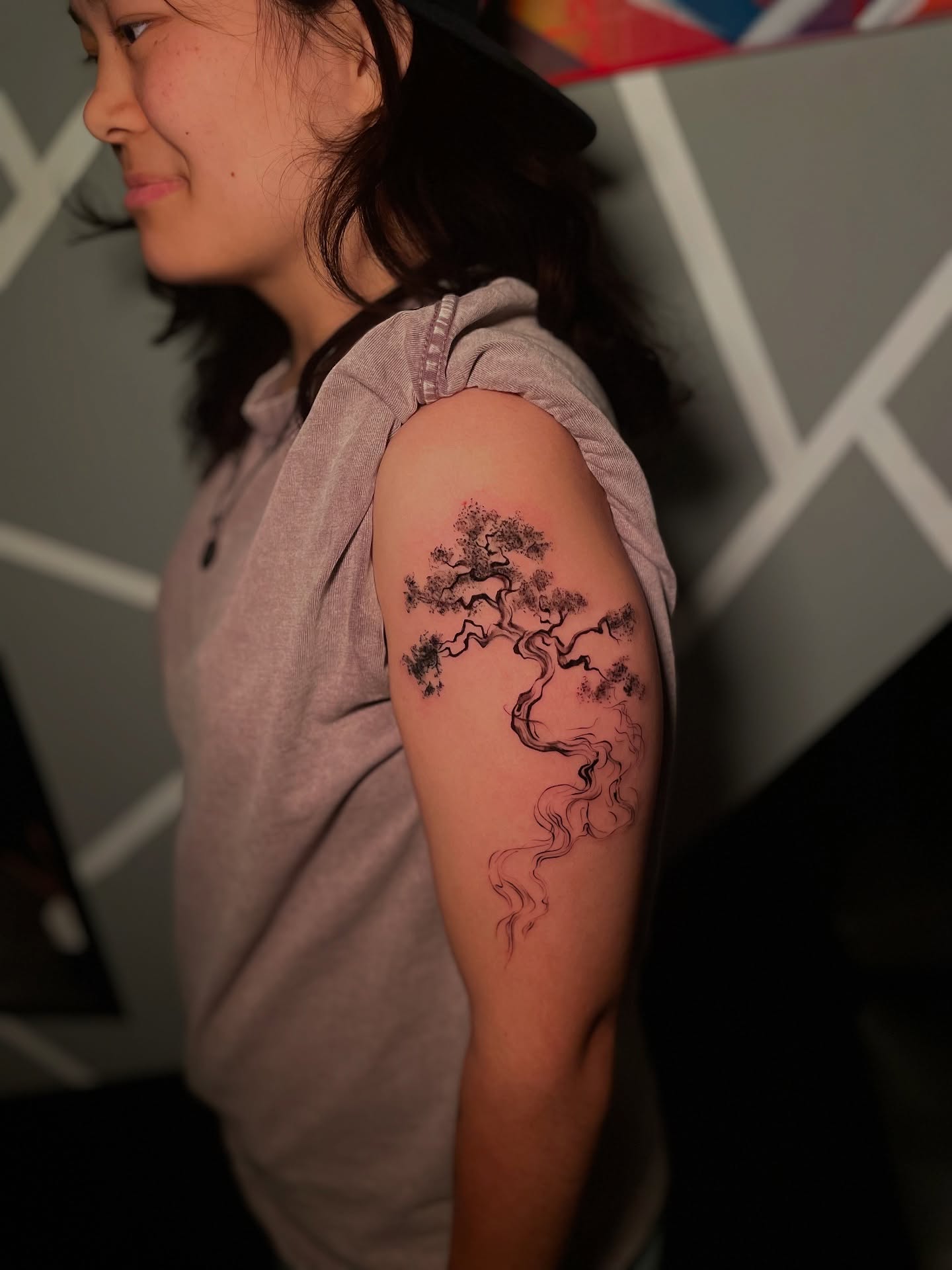 Bonsai tree black and grey tattoo on the upper arm by Tattoo Artist