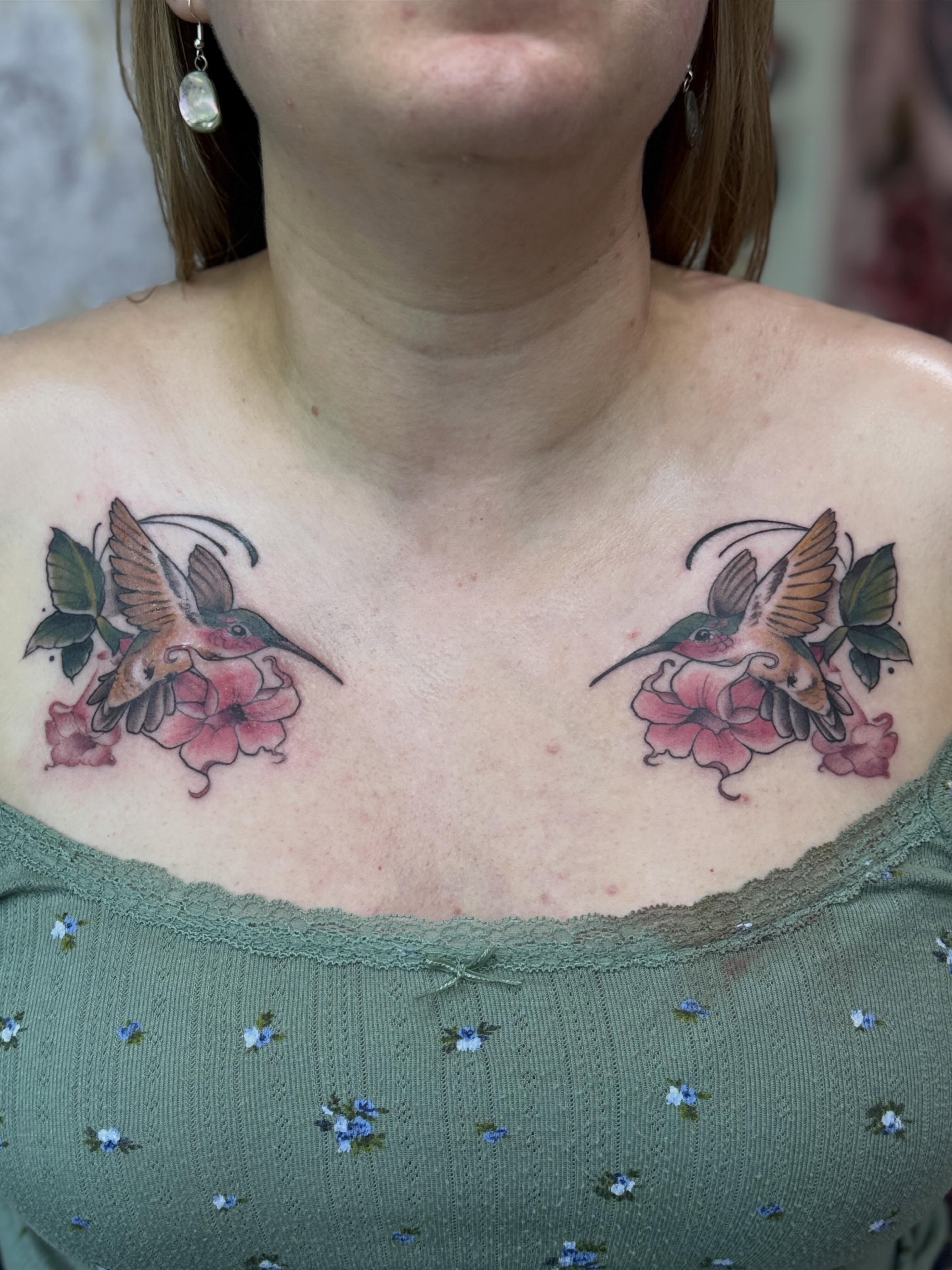 Hummingbirds and flowers American traditional tattoo on the chest by Rebecca Rose