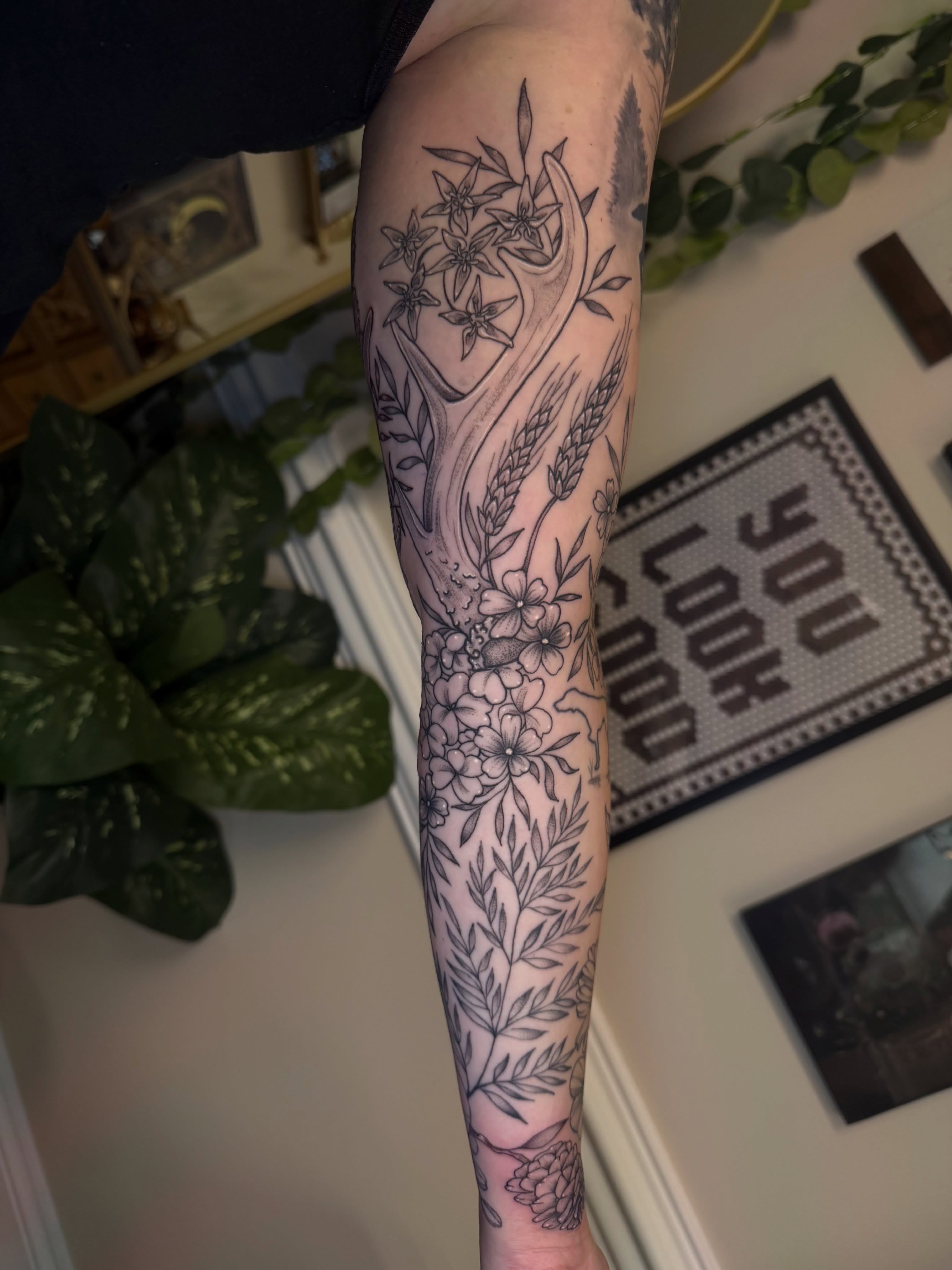 Floral arrangement black and grey tattoo on the forearm by McKenna
