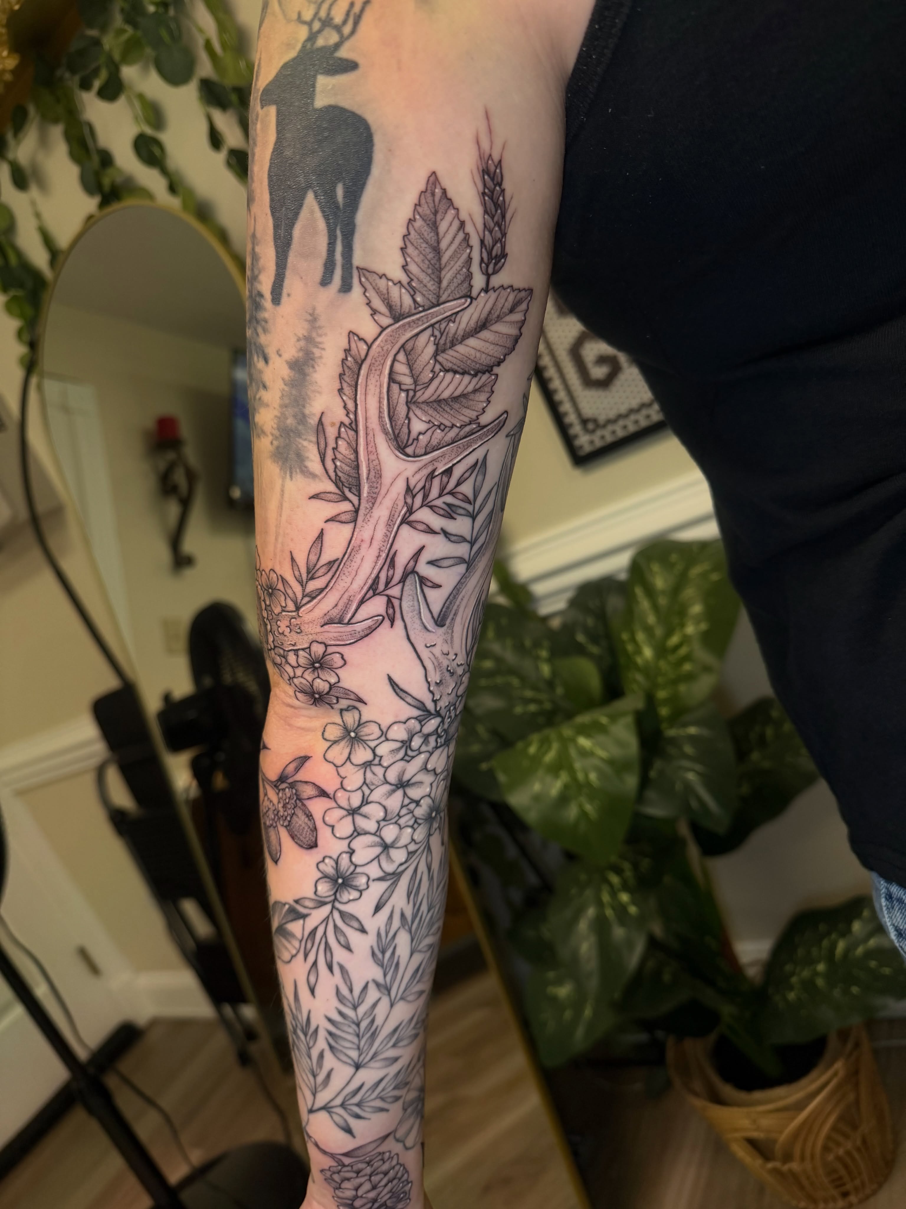 Deer and floral realism tattoo on the forearm by McKenna