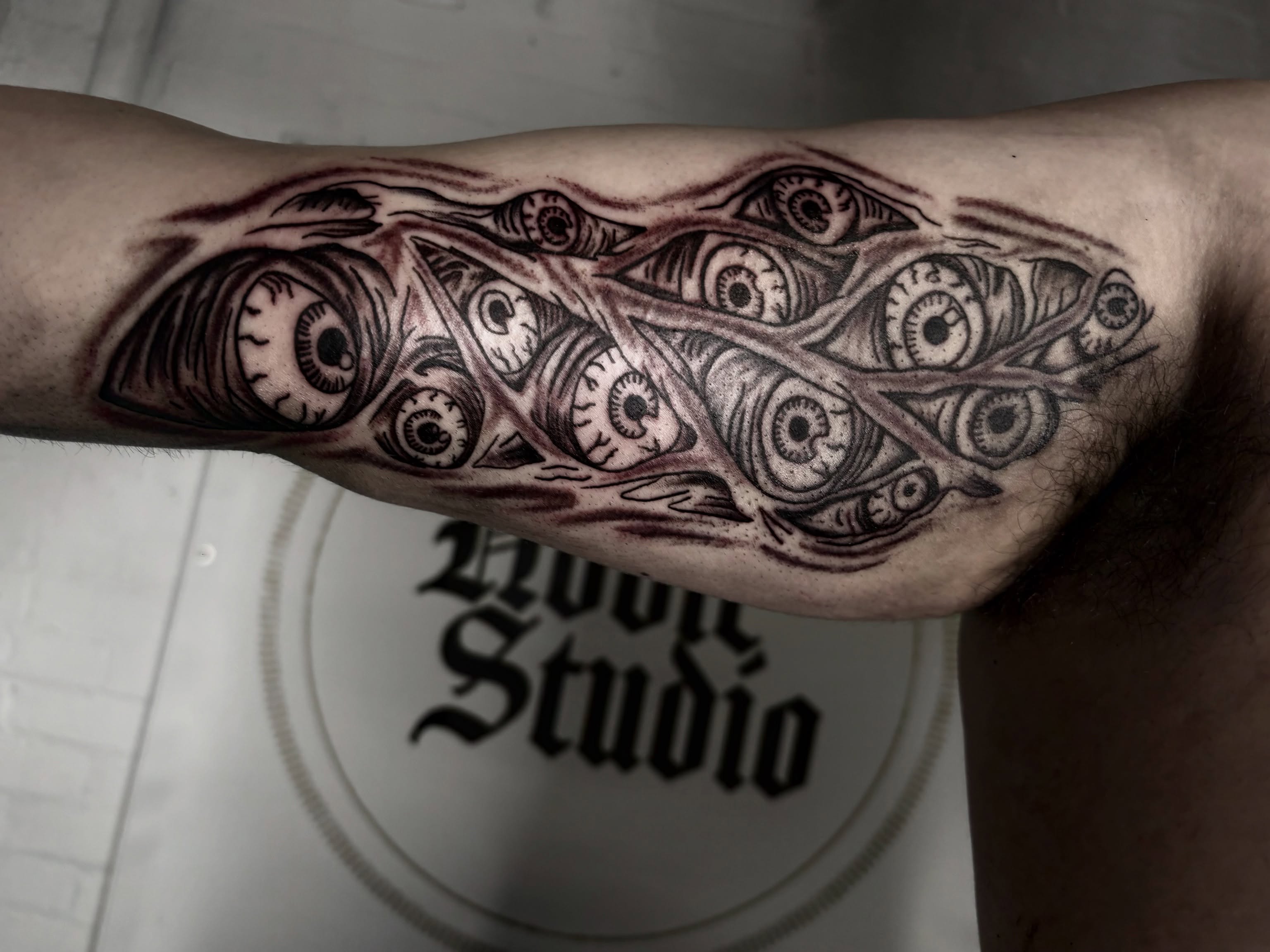 Eyes geometric tattoo on the forearm by Landon Bagley