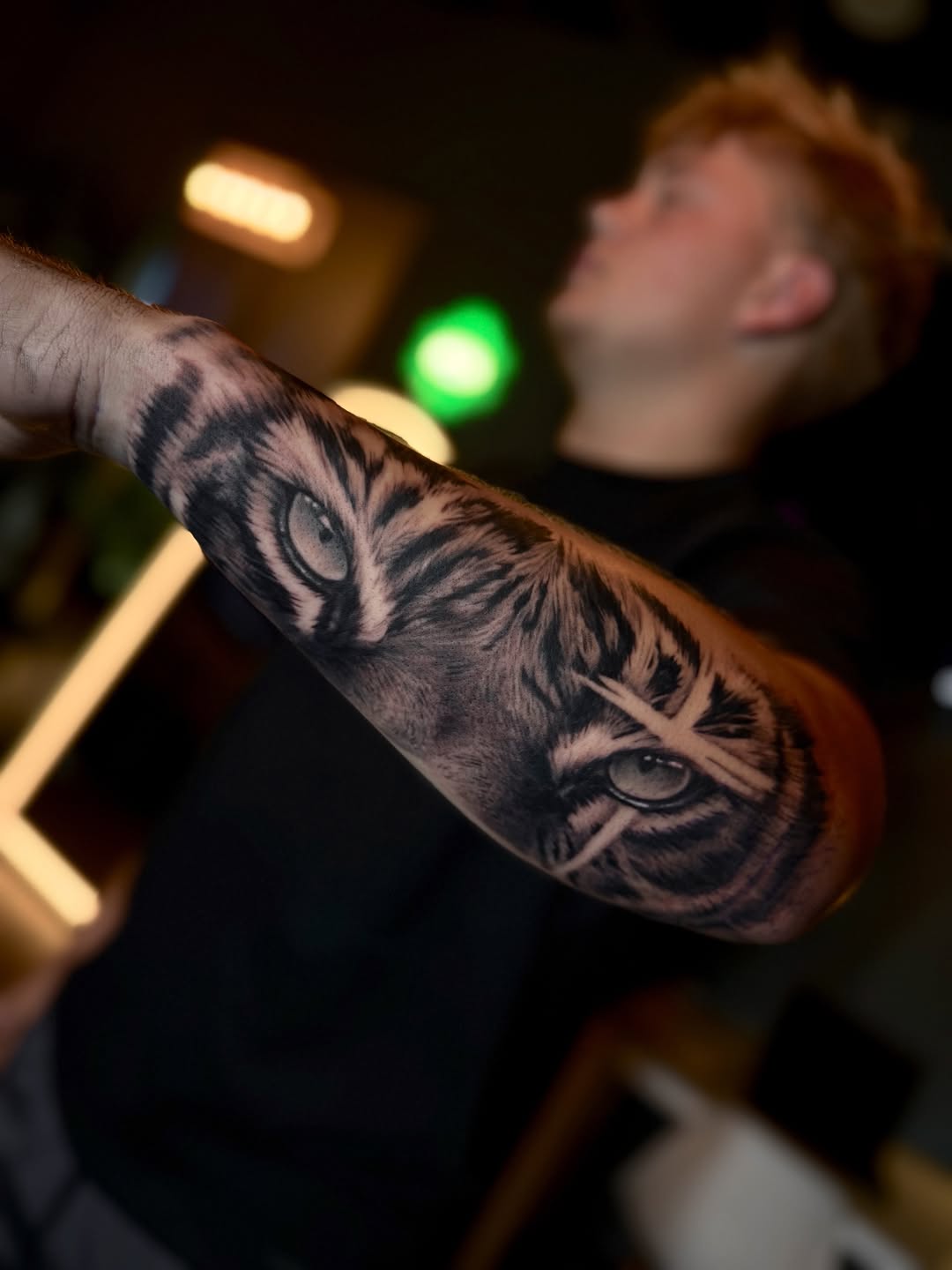 Tiger eyes realism tattoo on the forearm by Jevon Glasco Tattoos