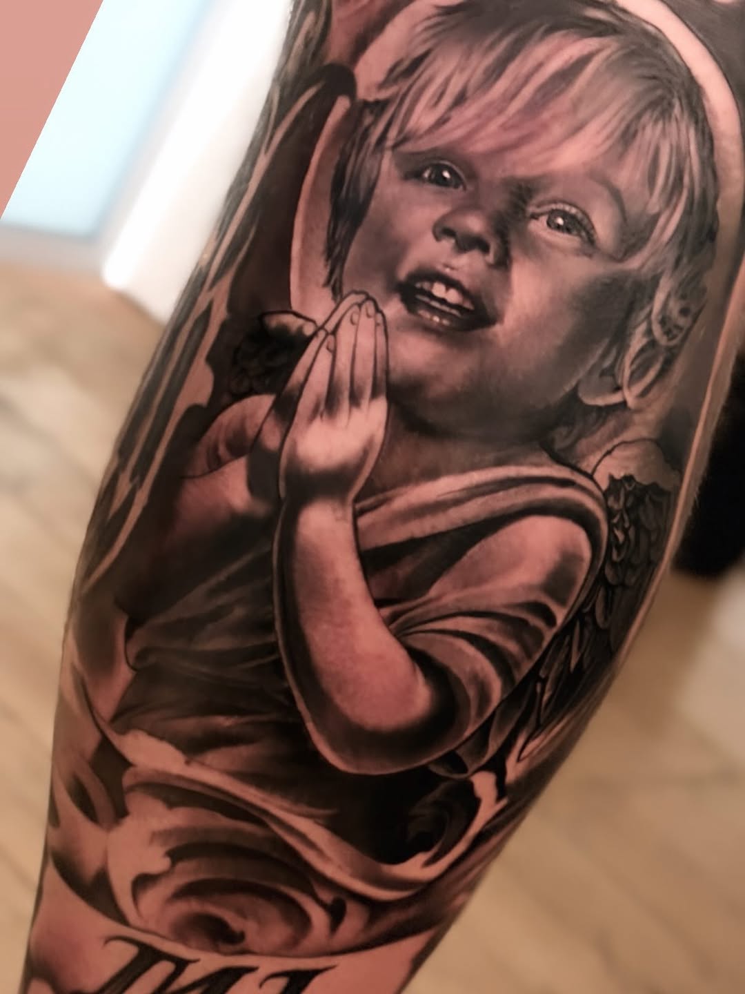 Cherub portrait realism tattoo on the forearm by Italo Holie