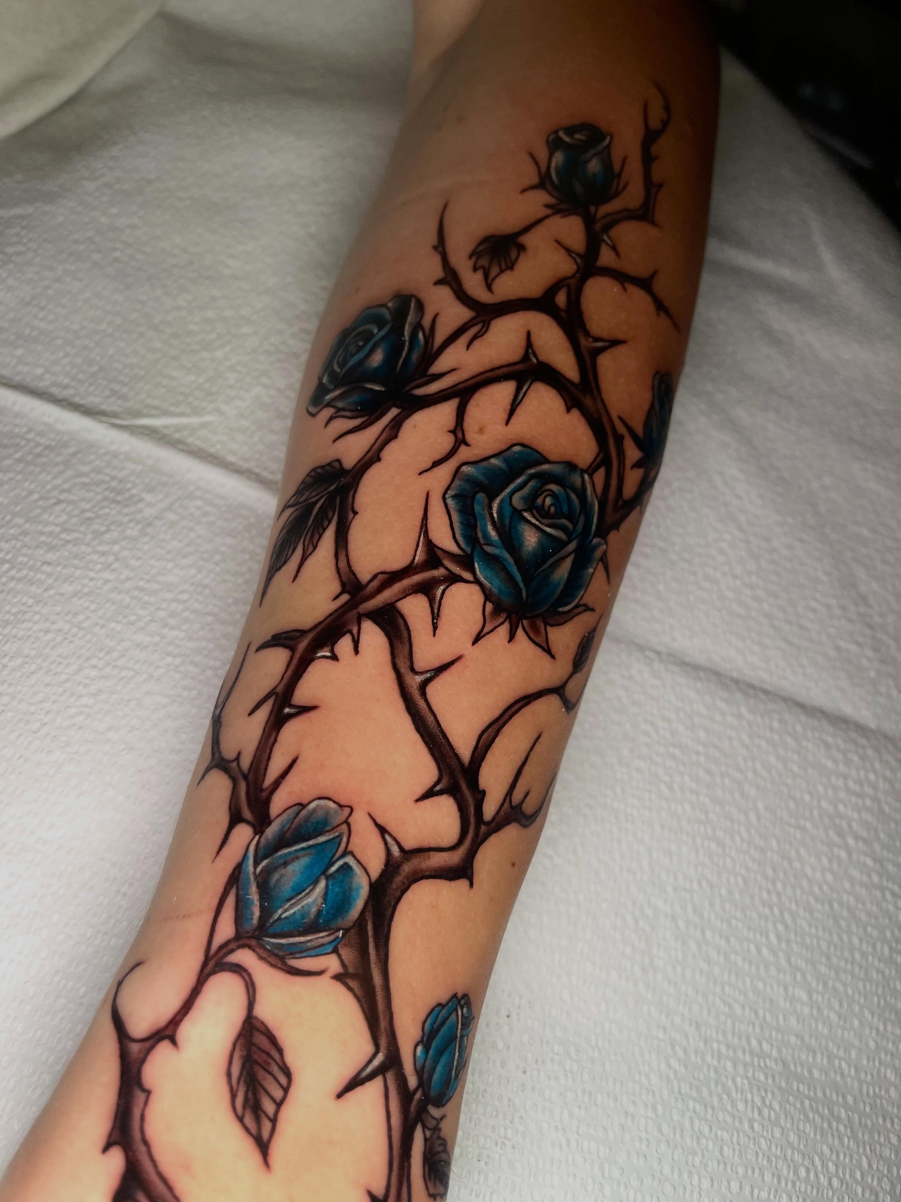 Blue roses American traditional tattoo on the forearm by Brooke Kresco