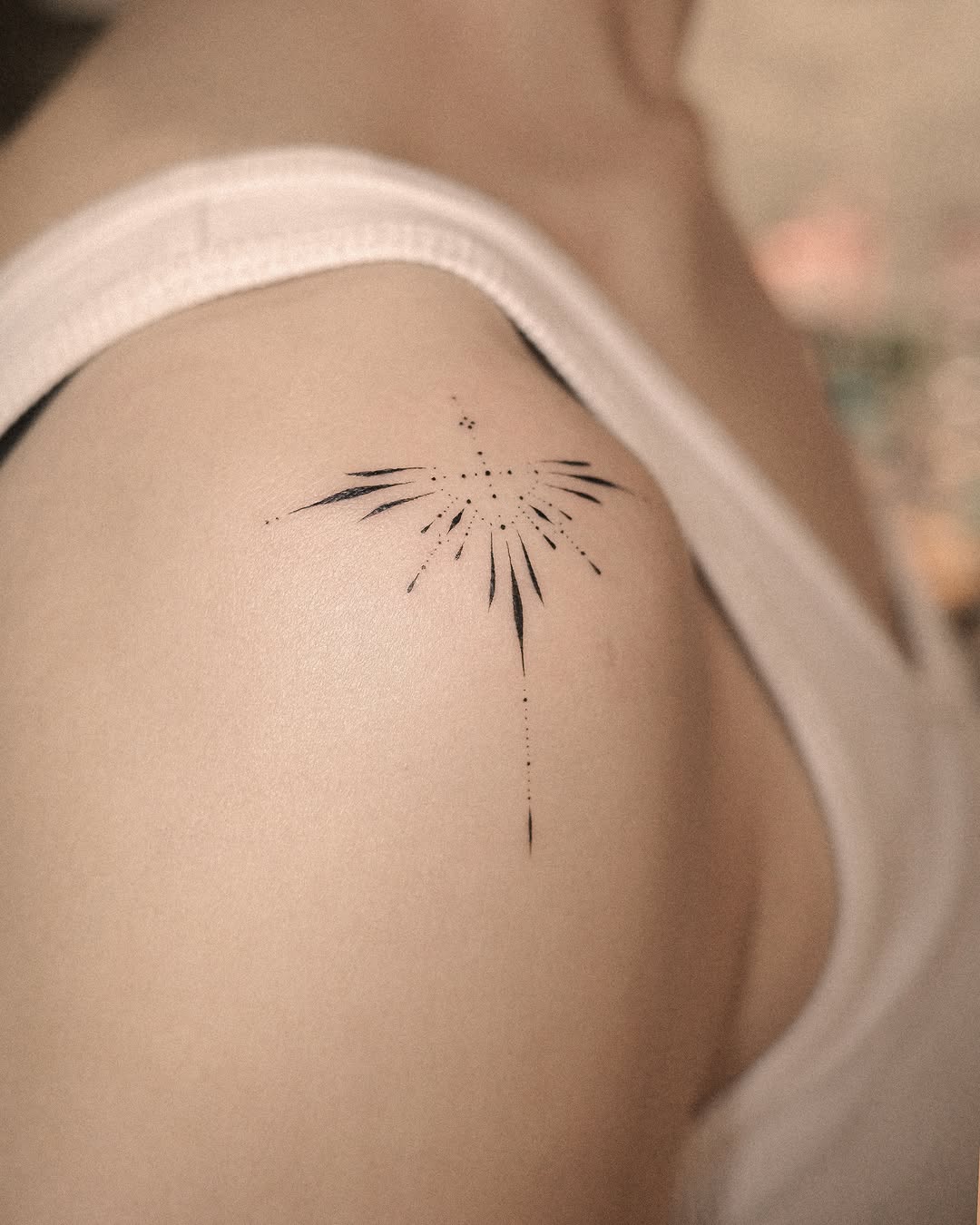 Abstract starburst sketch tattoo on the shoulder by Easy
