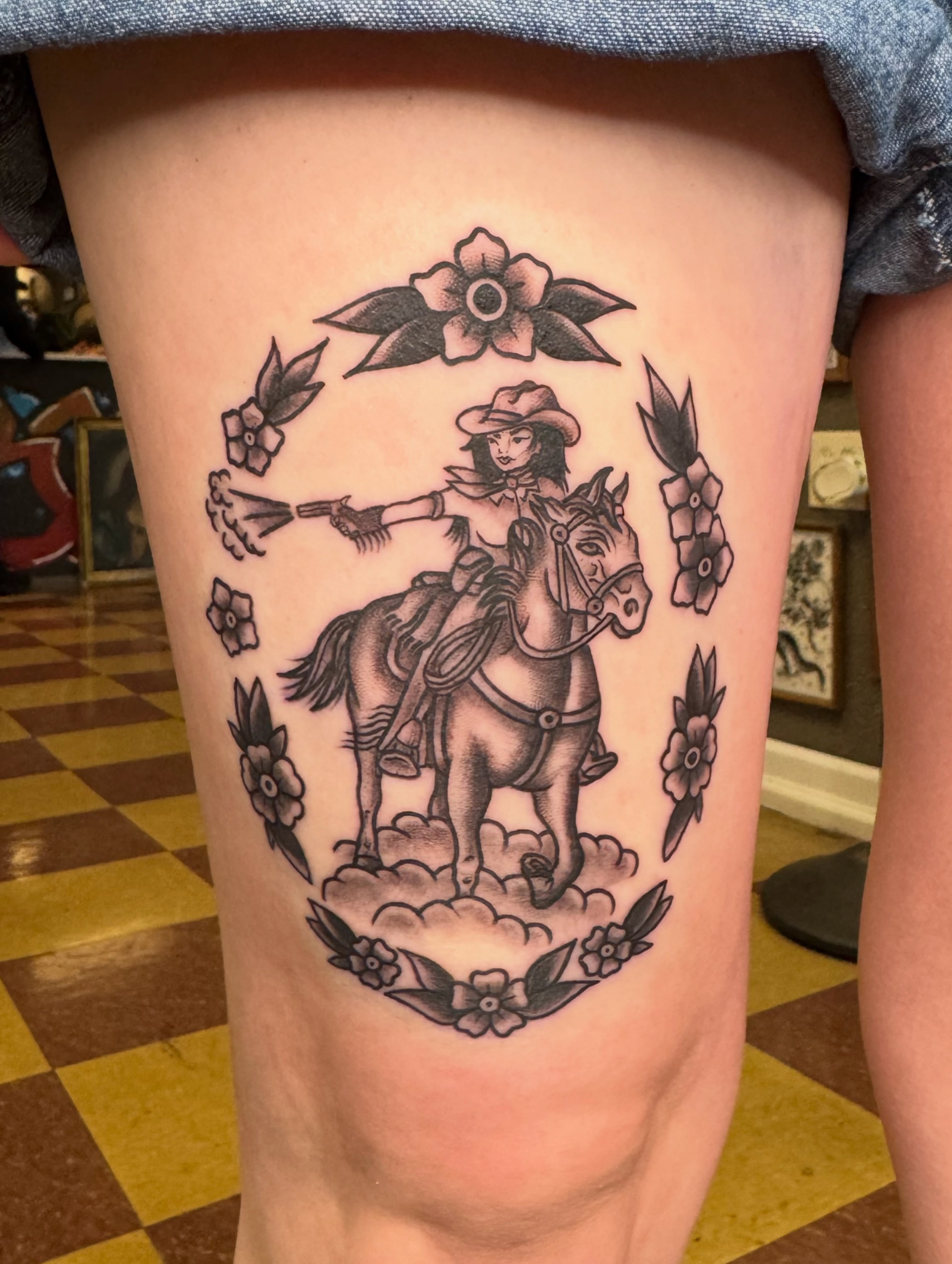 Cowgirl on horse American traditional tattoo on the thigh by Cora Phelps