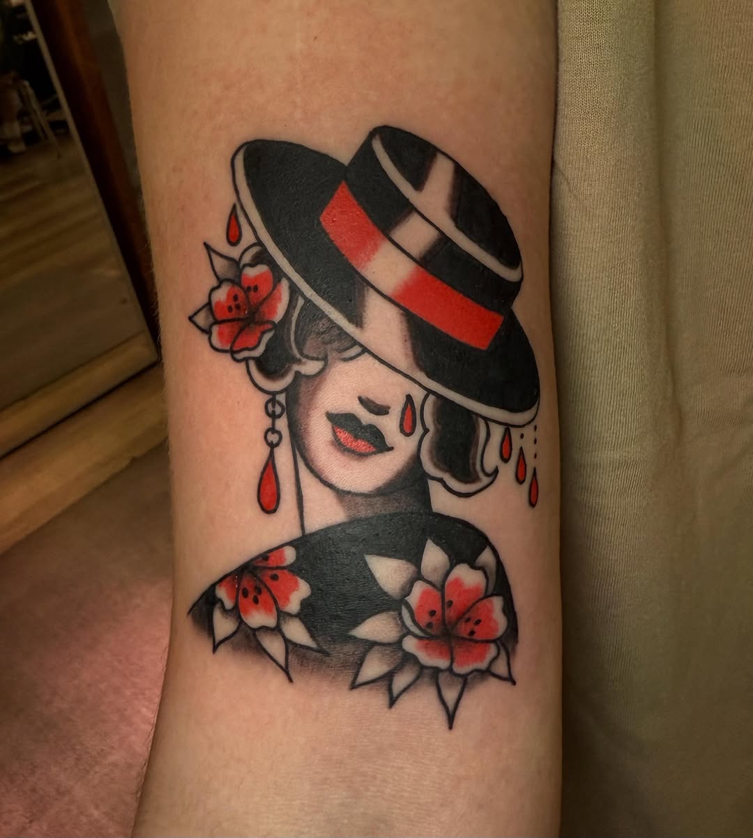 Woman with hat and flowers neo-traditional tattoo on the forearm by Rigo Vargas