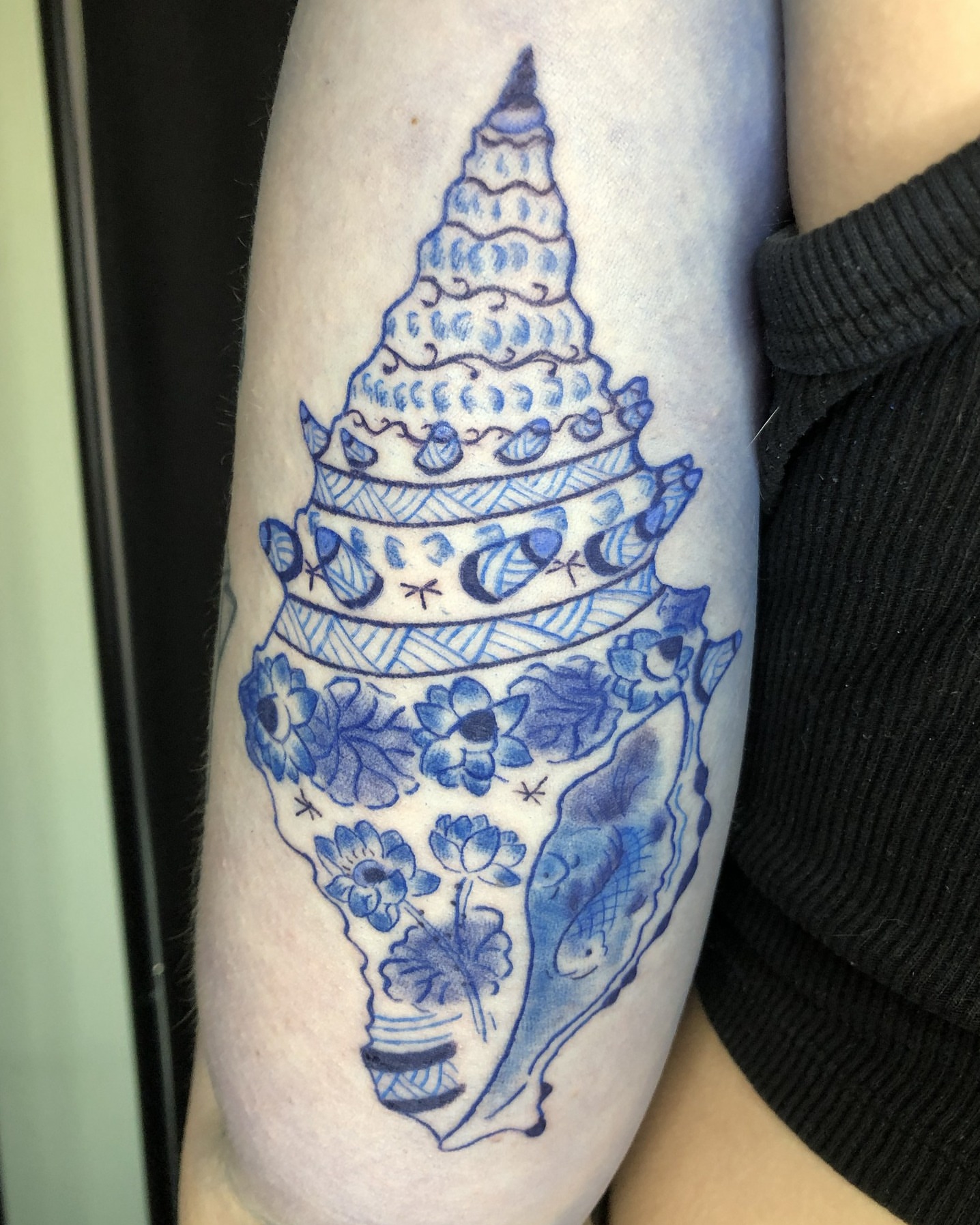 Shell ornamental tattoo on the forearm by Rowan Lee
