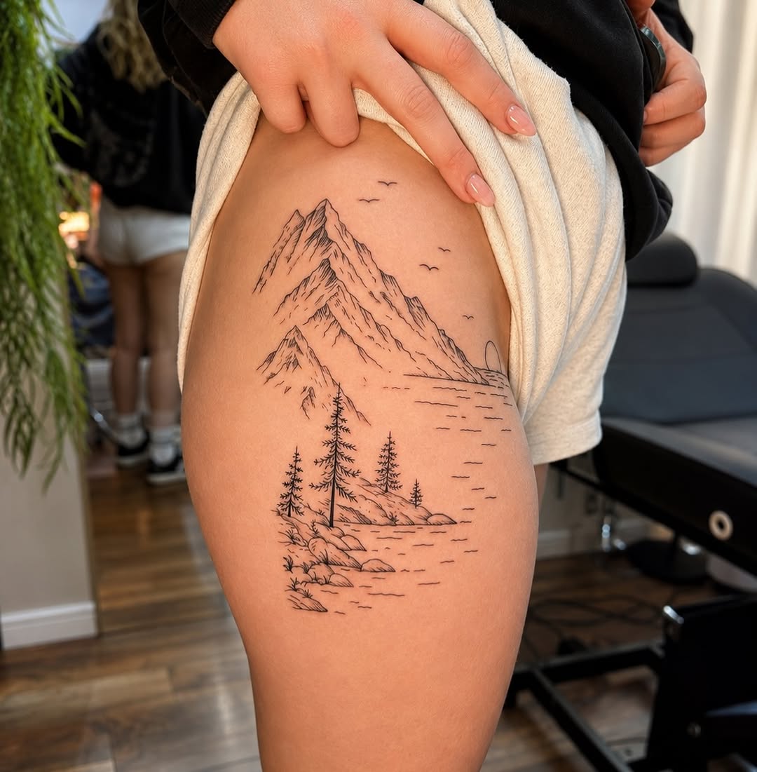 Mountain landscape with lake fine line tattoo on the thigh by JAmy Winters