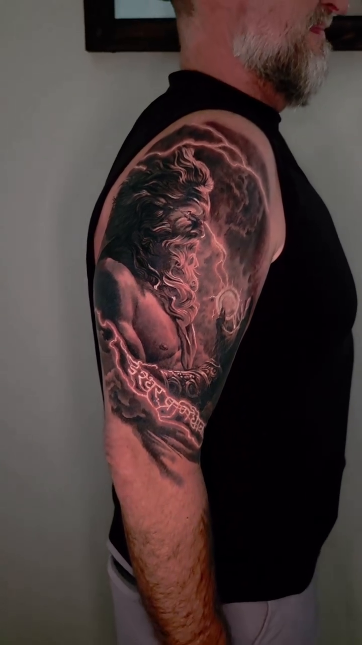 Zeus with lightning realism tattoo on the upper arm by Preston