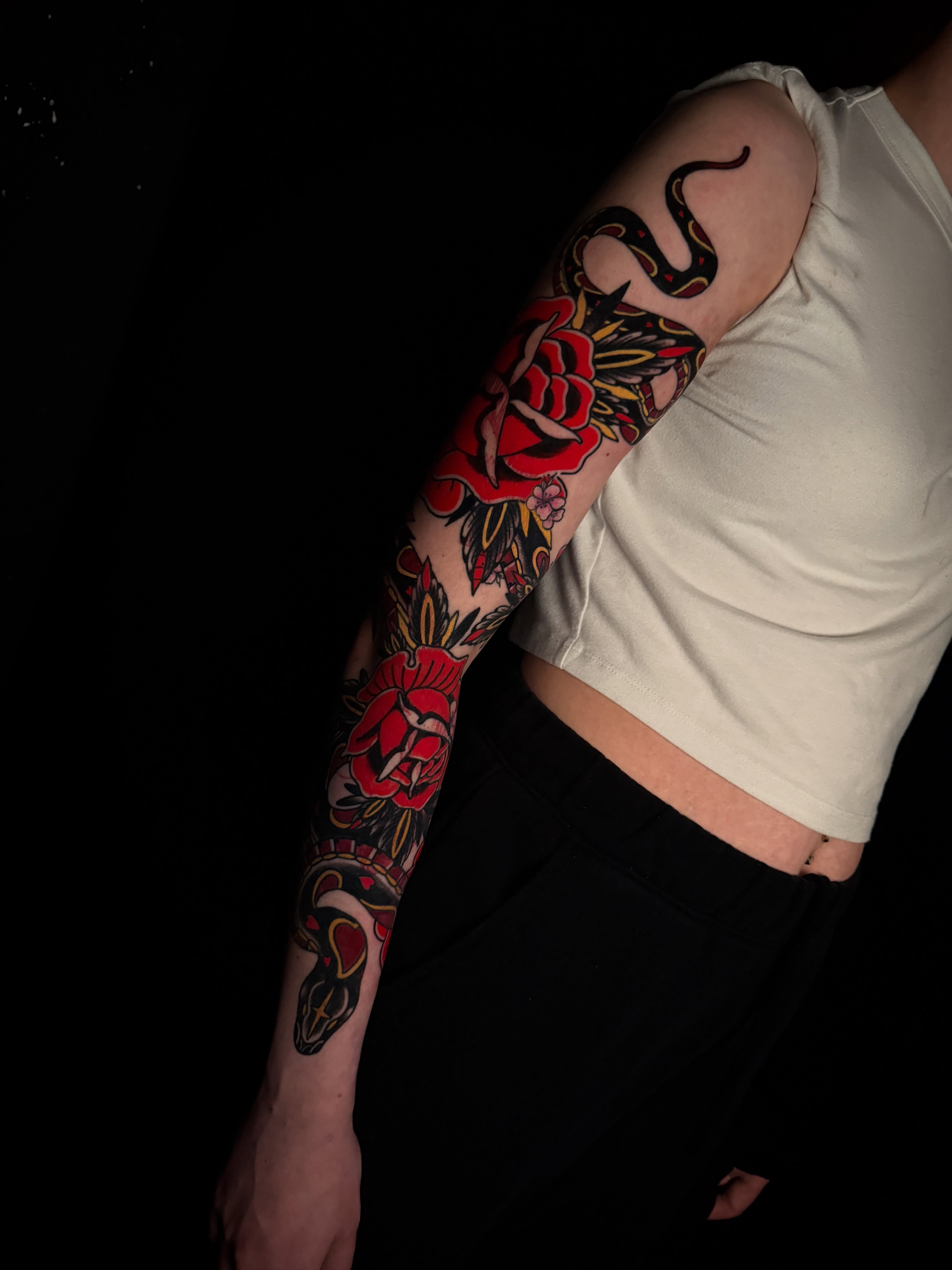 Rose and snake American traditional tattoo on the forearm by Brad Snow