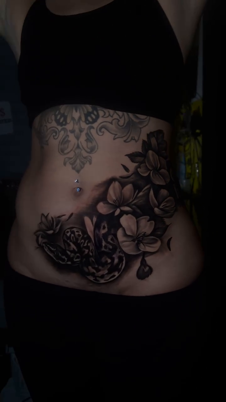 Floral cover-up tattoo on abdomen realism tattoo on the torso by Chicago Tattoo Artist