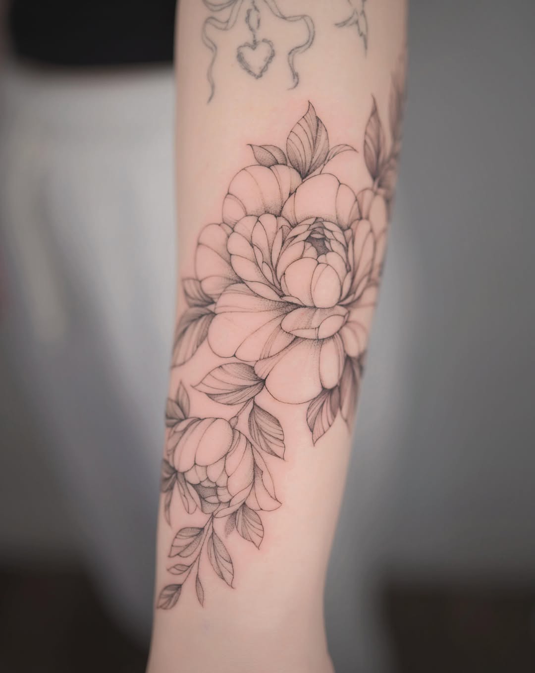Peony black and grey tattoo on the forearm by Seattle tattoo artist-Mia