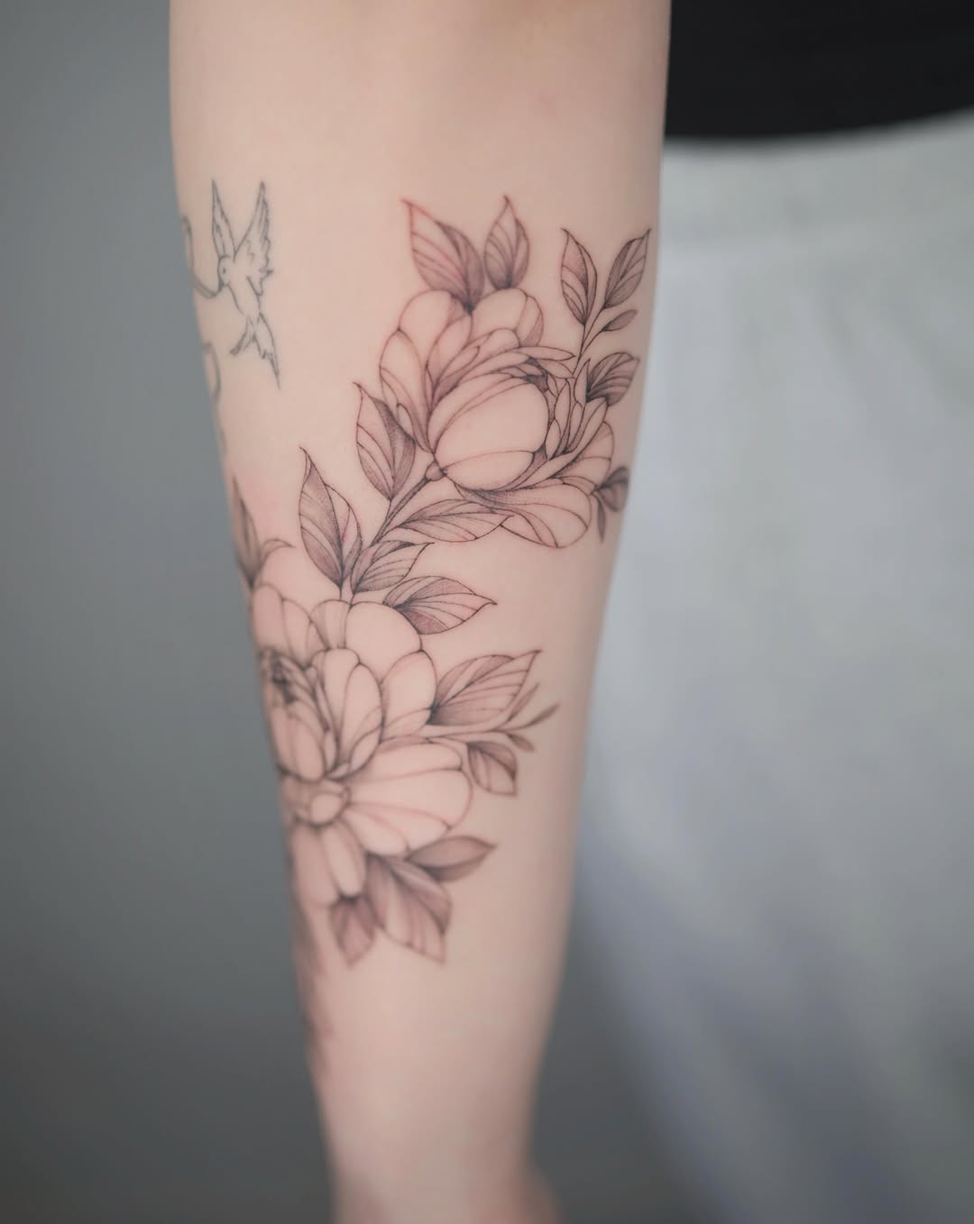 Flowers and birds black and grey tattoo on the forearm by Seattle tattoo artist-Mia