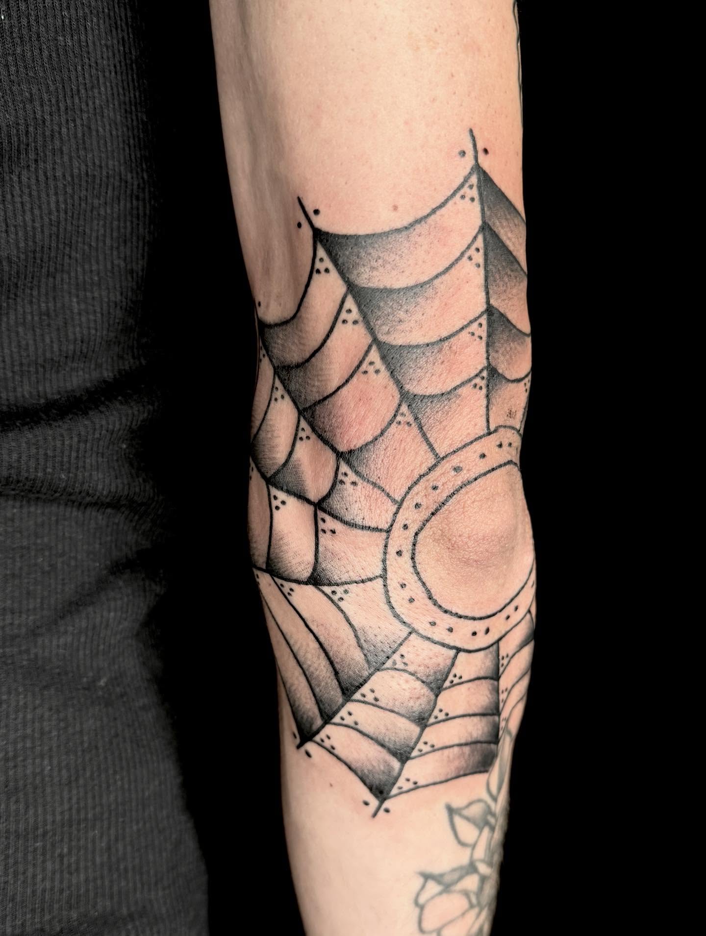 Spiderweb dotwork tattoo on the forearm by Cody Glenn