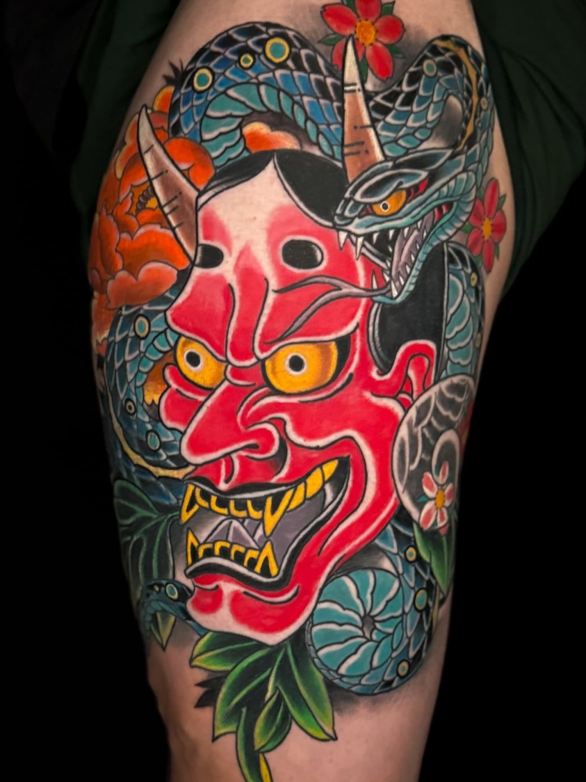 Demon mask American traditional tattoo on the thigh by Chris Cockrill