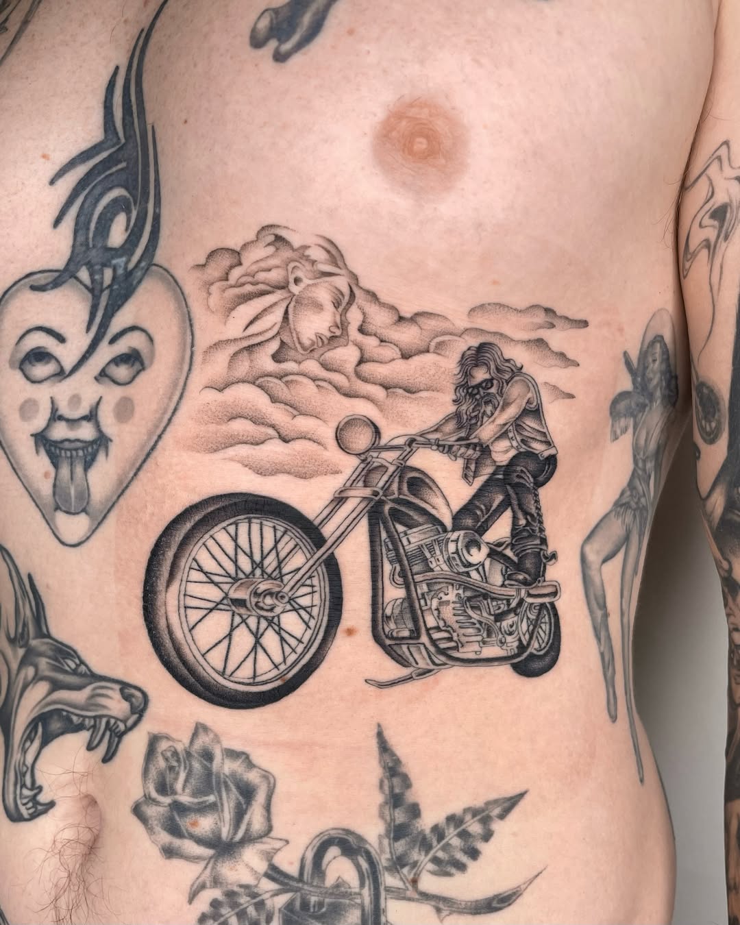 Motorcycle rider realism tattoo on the torso by IVY