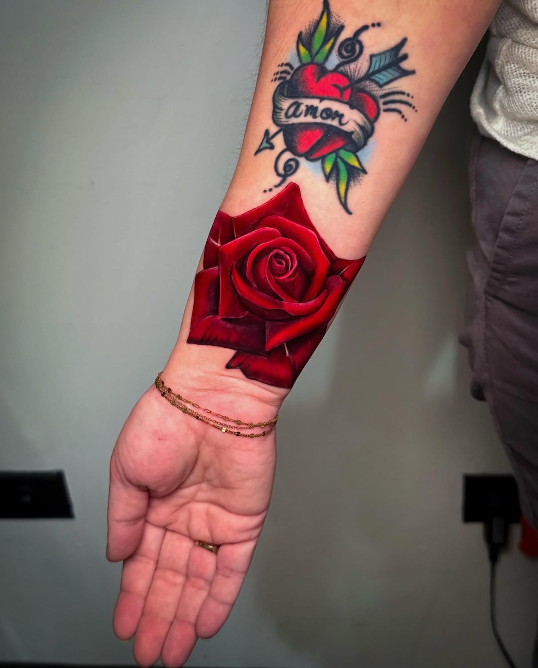 Red rose American traditional tattoo on the forearm by 𝕀𝕣𝕚𝕤 𝔸𝕣𝕖𝕝𝕝𝕒𝕟𝕠