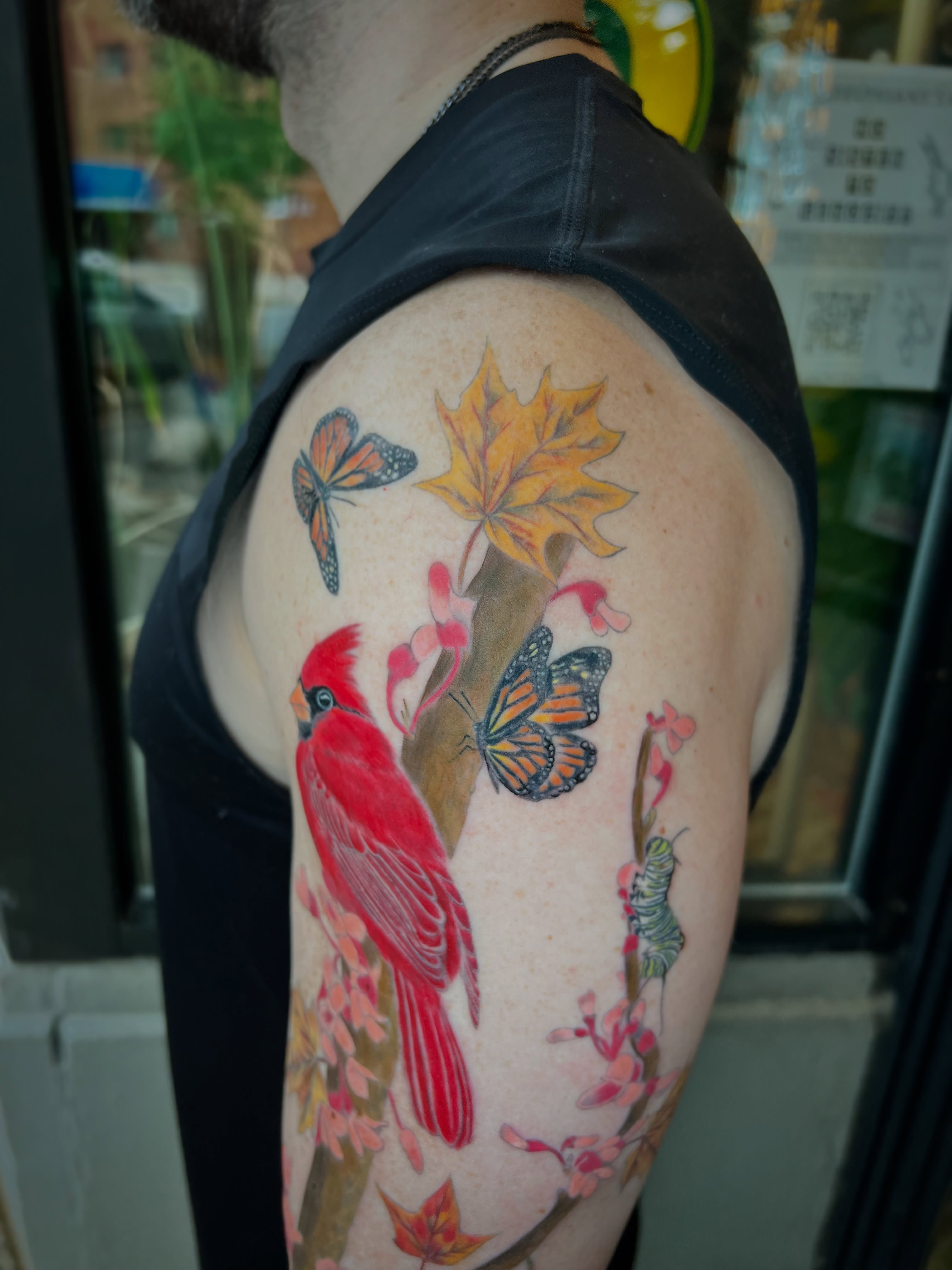Cardinal and butterflies realism tattoo on the shoulder by Jen Rahman