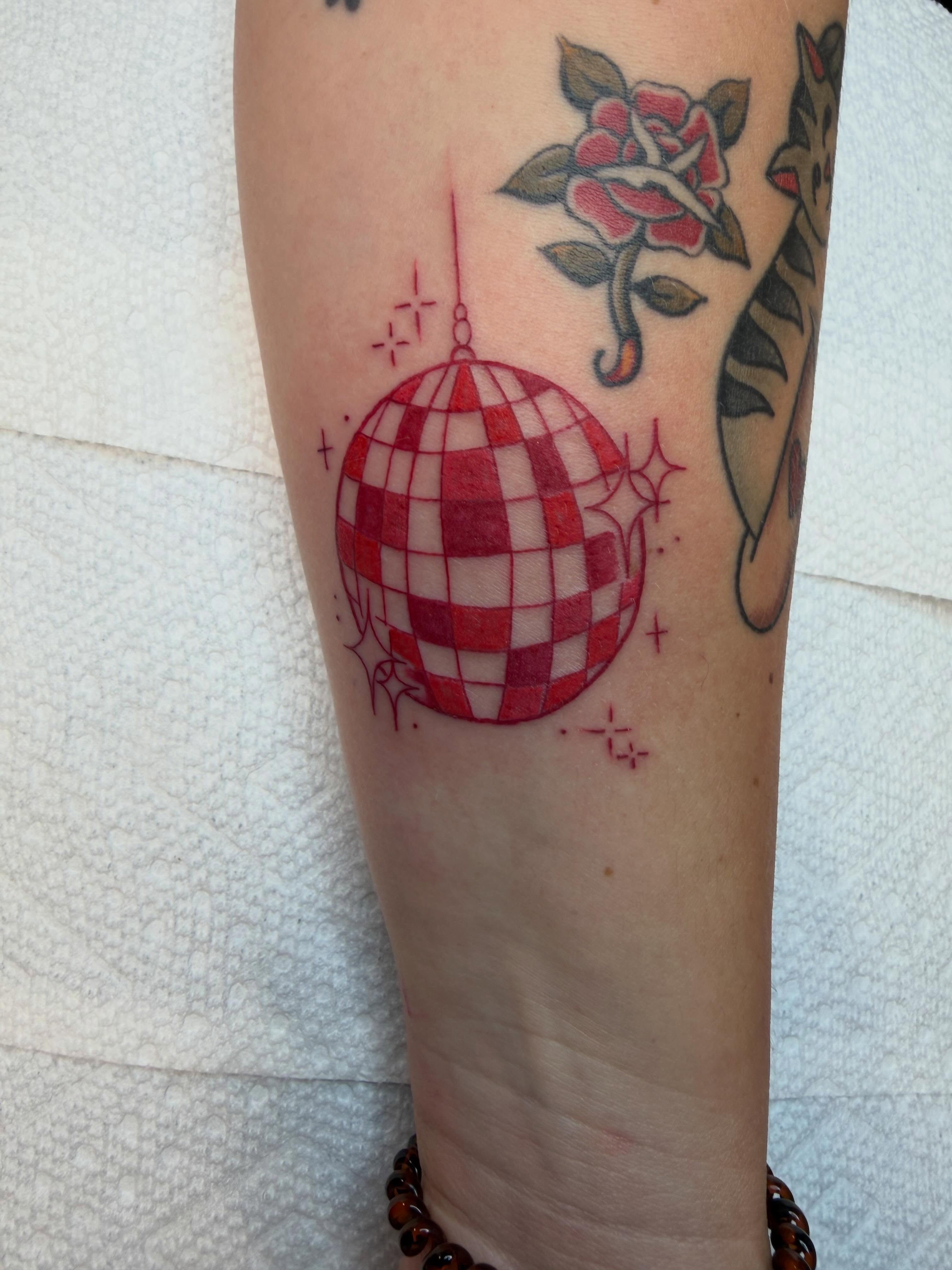 Disco ball American traditional tattoo on the forearm by Evan Voelker