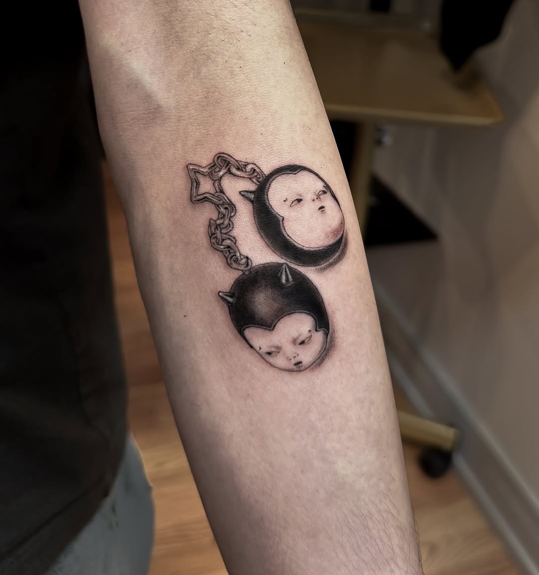 Two heads on a chain new school tattoo on the forearm by Hery Anwar