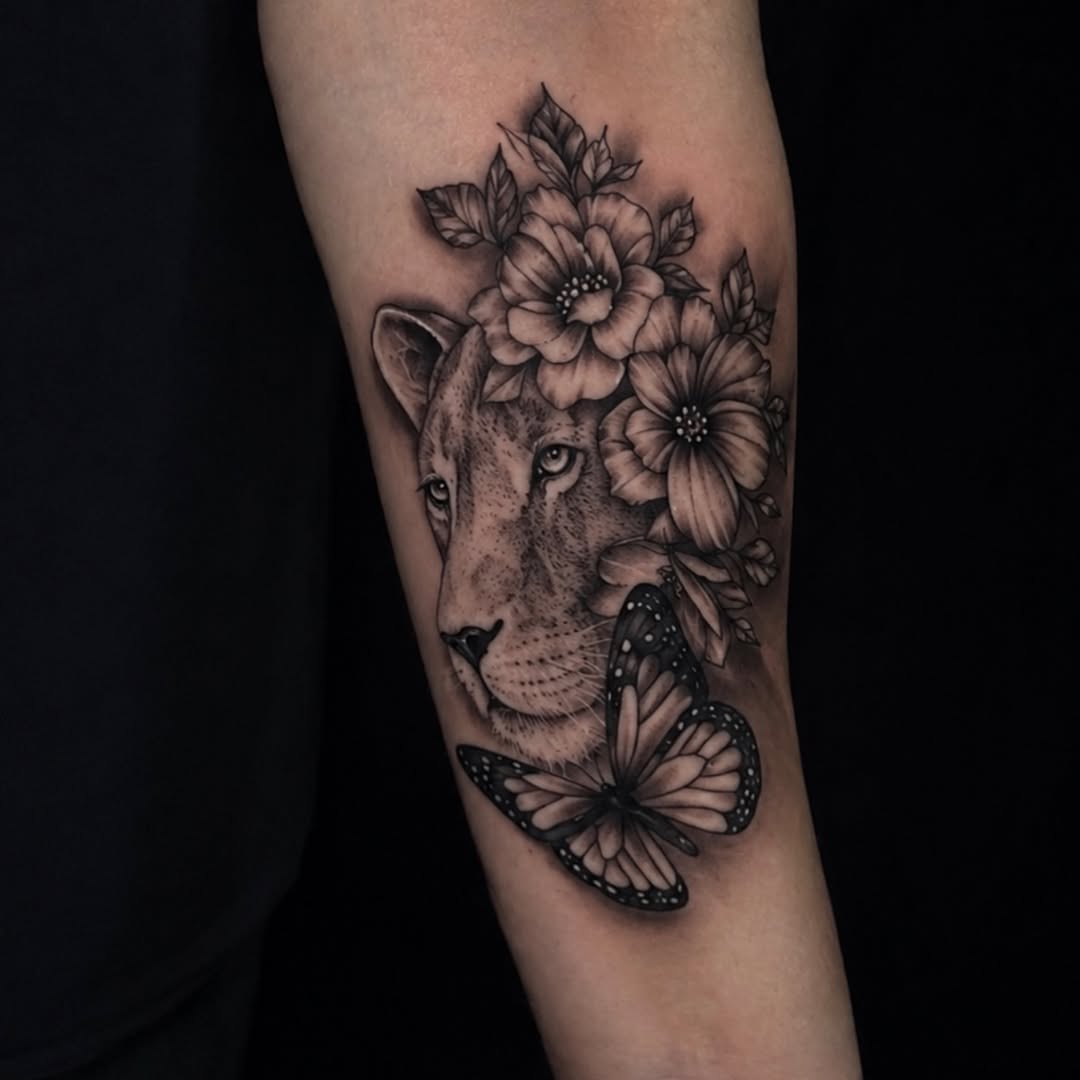 Lioness with flowers and butterfly fine line tattoo on the forearm by Felix perez (Tattooer)
