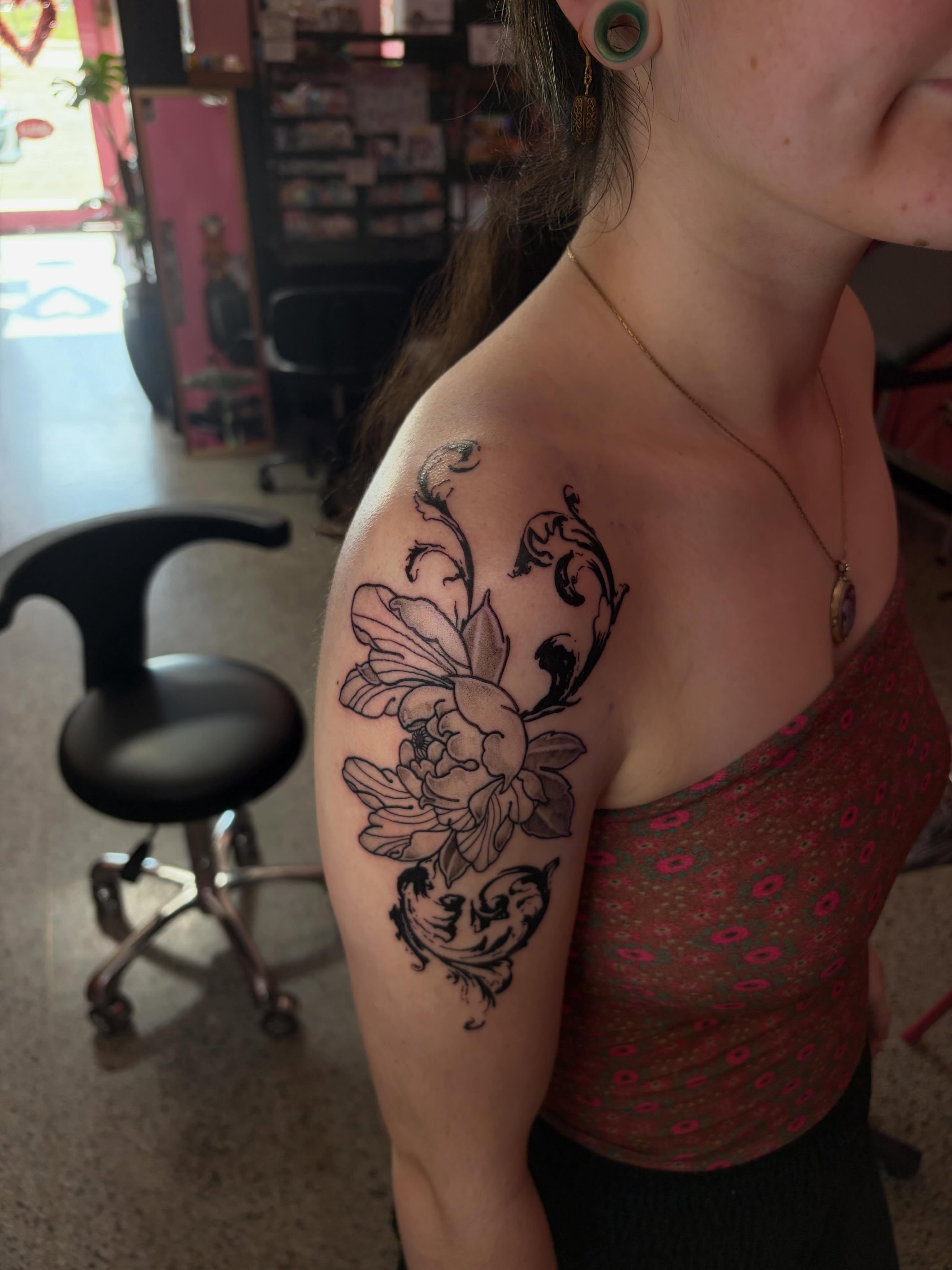 Floral design black and grey tattoo on the shoulder by neal