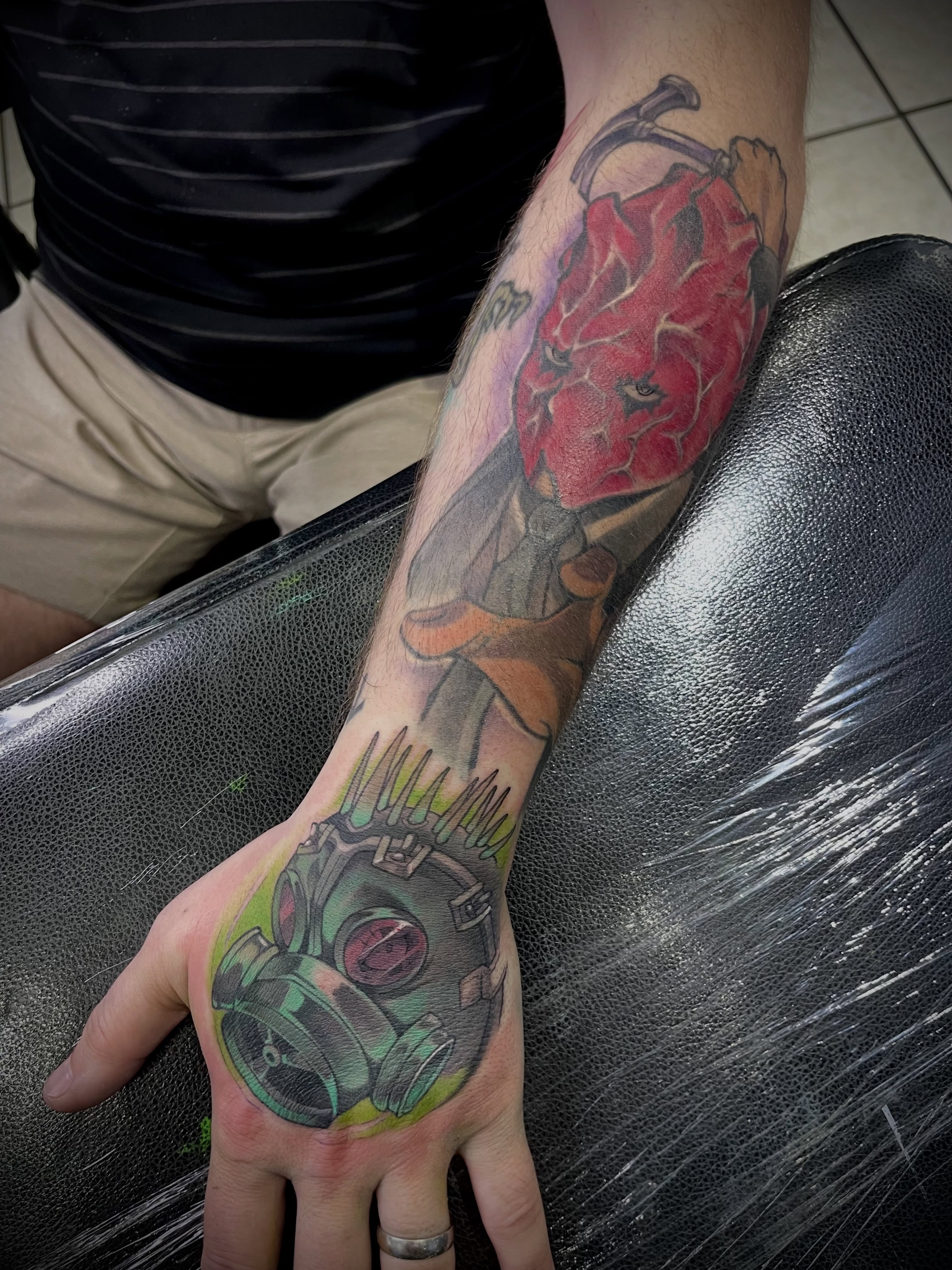 Gas mask and chili pepper realism tattoo on the hand by Airi
