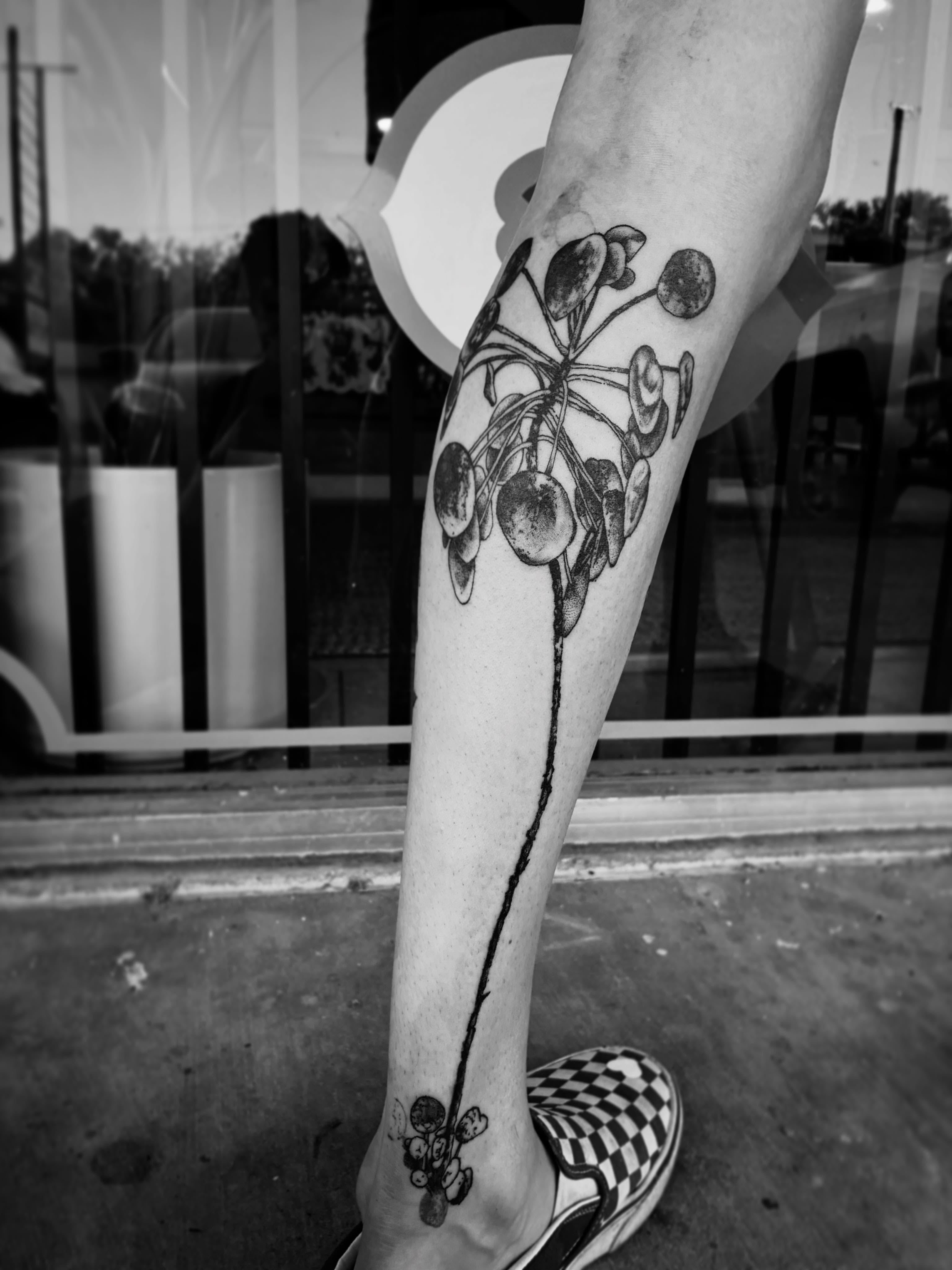 Cherries black and grey tattoo on the calf by Zachary R Bobkoff