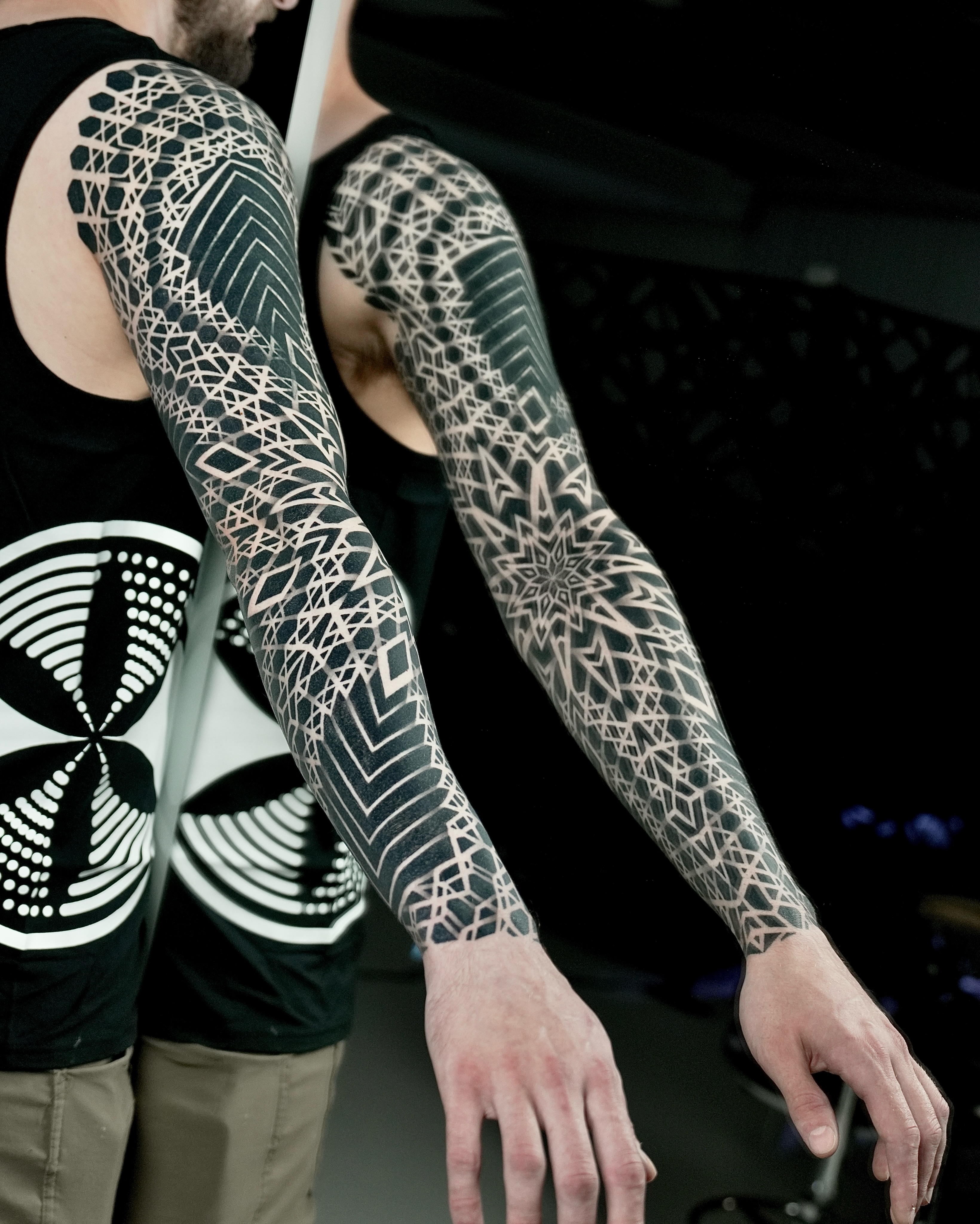 Geometric pattern sleeve geometric tattoo on the upper arm by Ilya Cascad Kandaurov