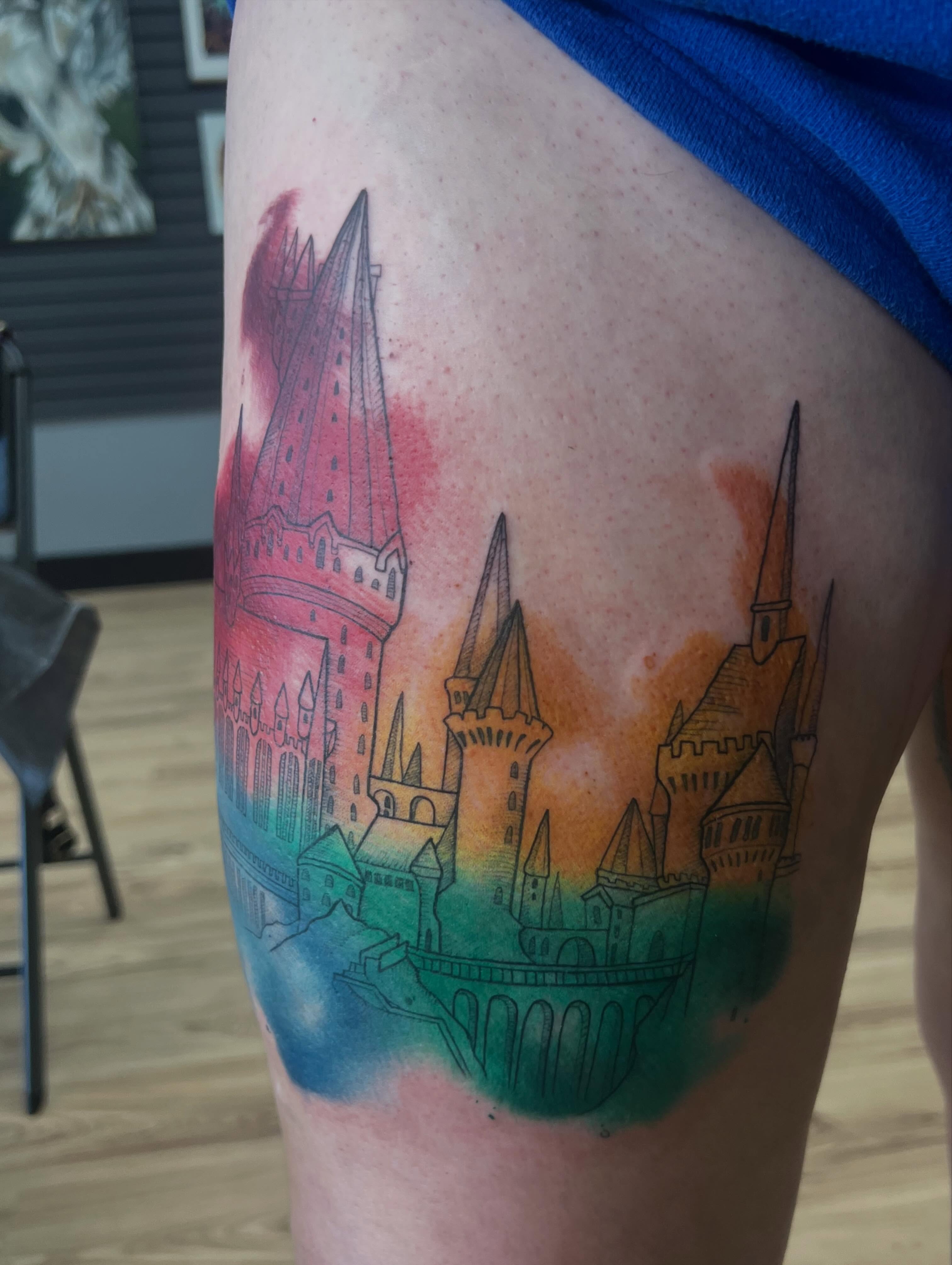 Hogwarts Castle watercolor tattoo on the thigh by Bailey Goodwin, Ankeny, Iowa