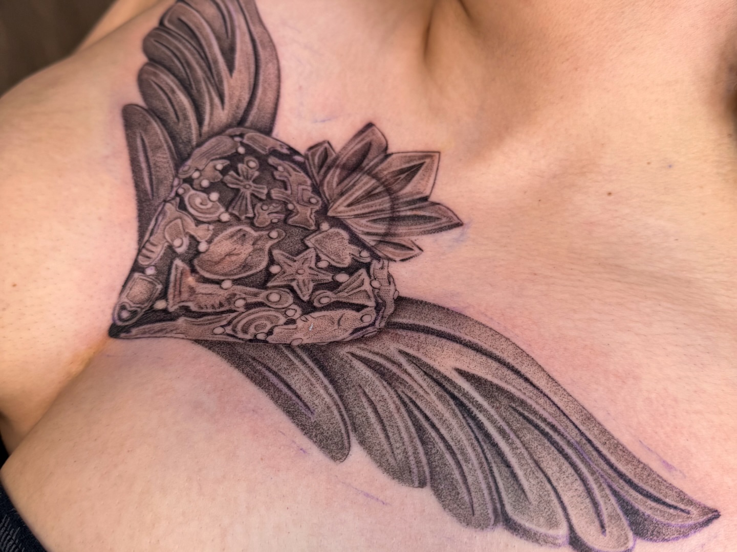 Winged helmet black and grey tattoo on the chest by @nudylicioustattoos