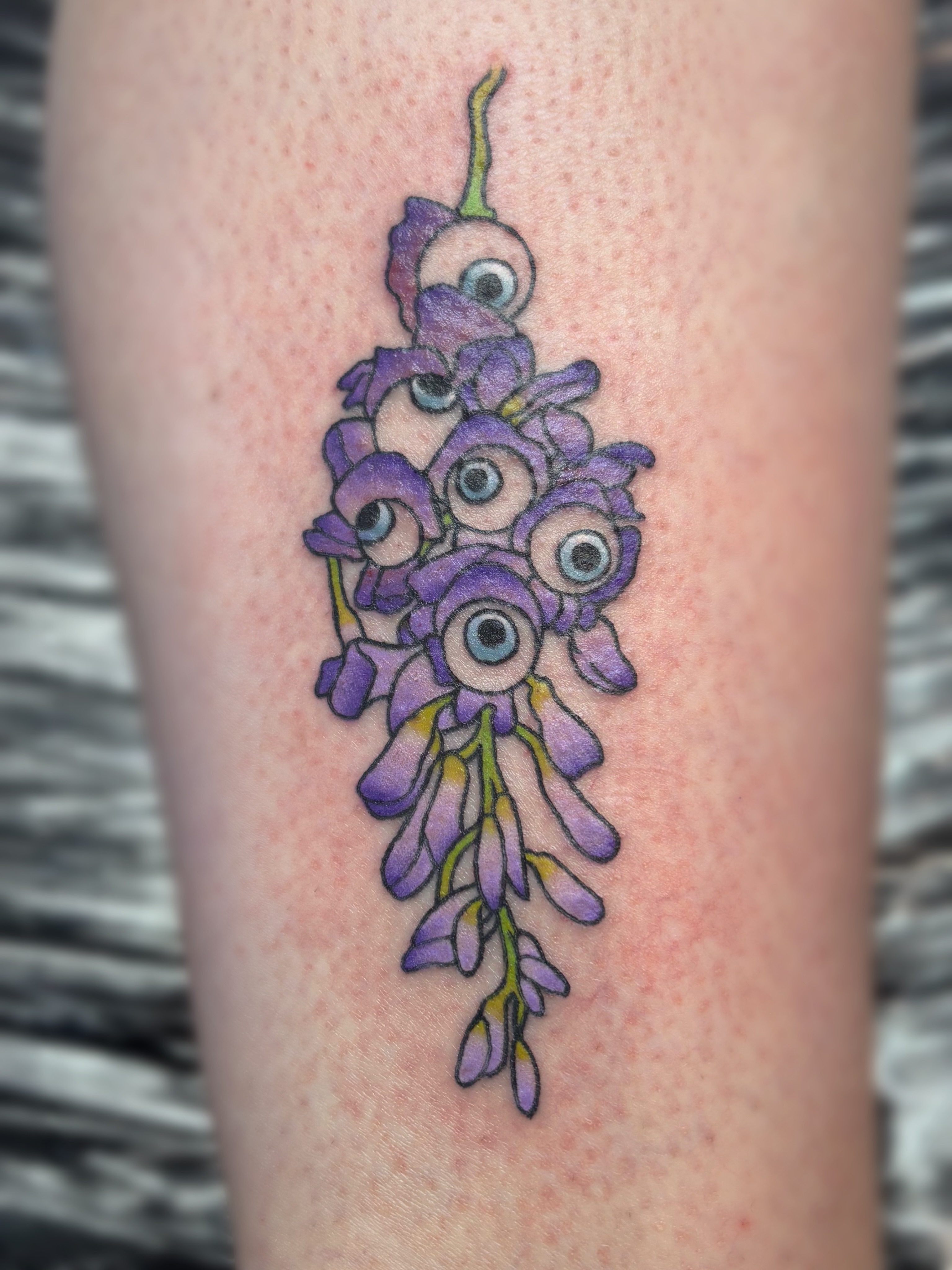 Wisteria with eyes new school tattoo on the thigh by Bree Burgess