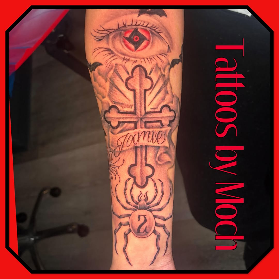 Eye, cross, spider, and banner Chicano tattoo on the forearm by Tattoos By Moch, Toledo, Ohio