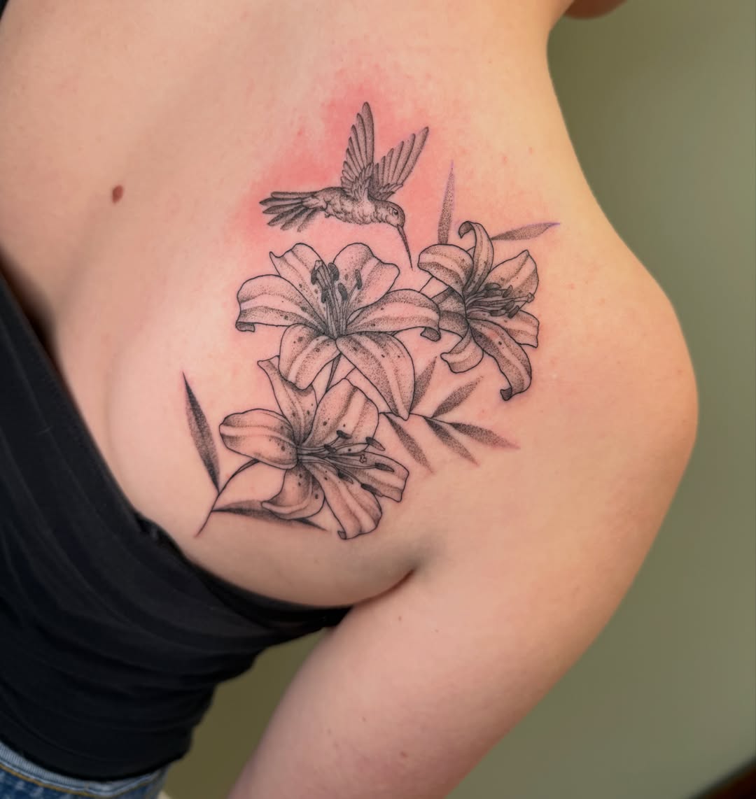 Lilies and hummingbird realism tattoo on the ribs by Koryn Donnelly