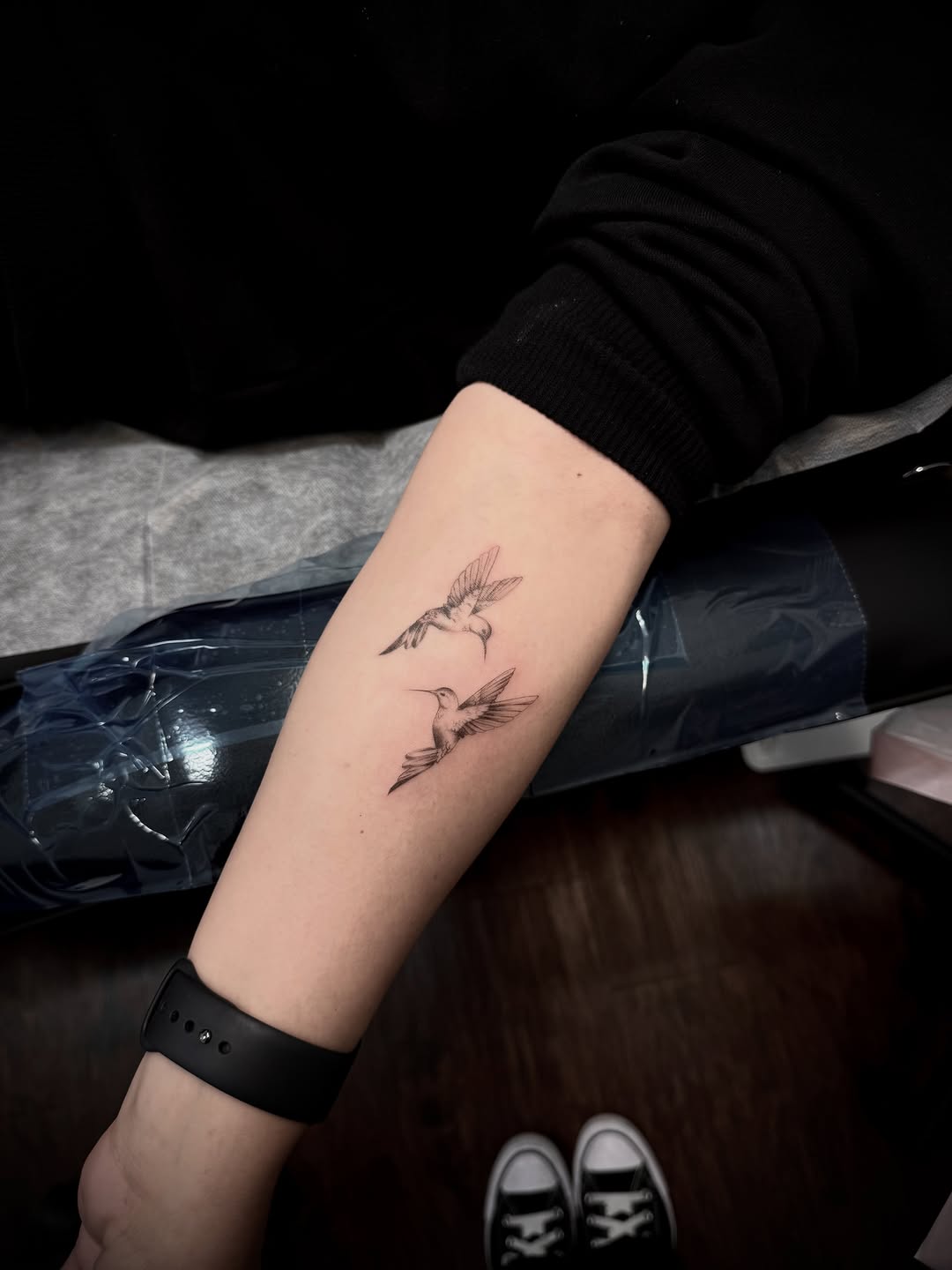 Two hummingbirds fine line tattoo on the forearm by Ava De La Torre