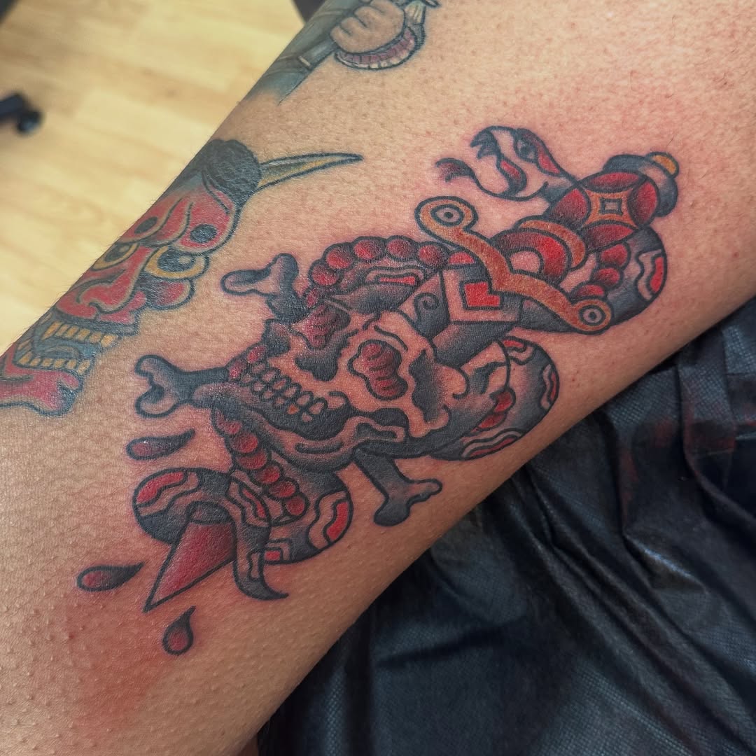 Skull and snake with dagger American traditional tattoo on the forearm by norawillstattoo