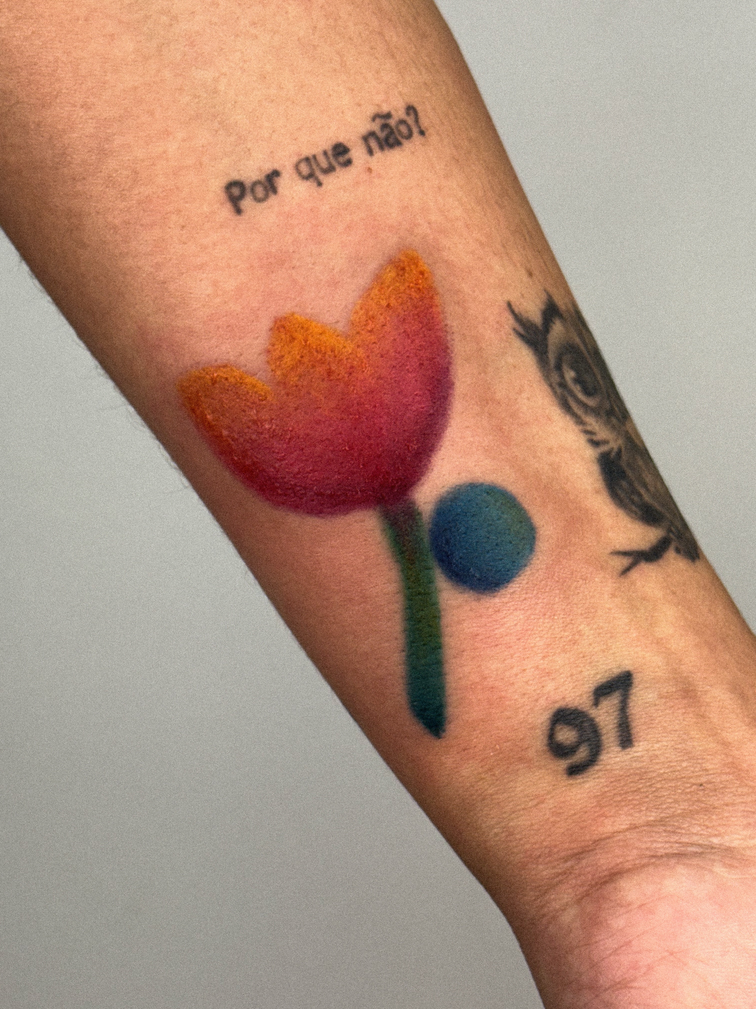 Tulip watercolor tattoo on the forearm by júlia sanches ✦︎